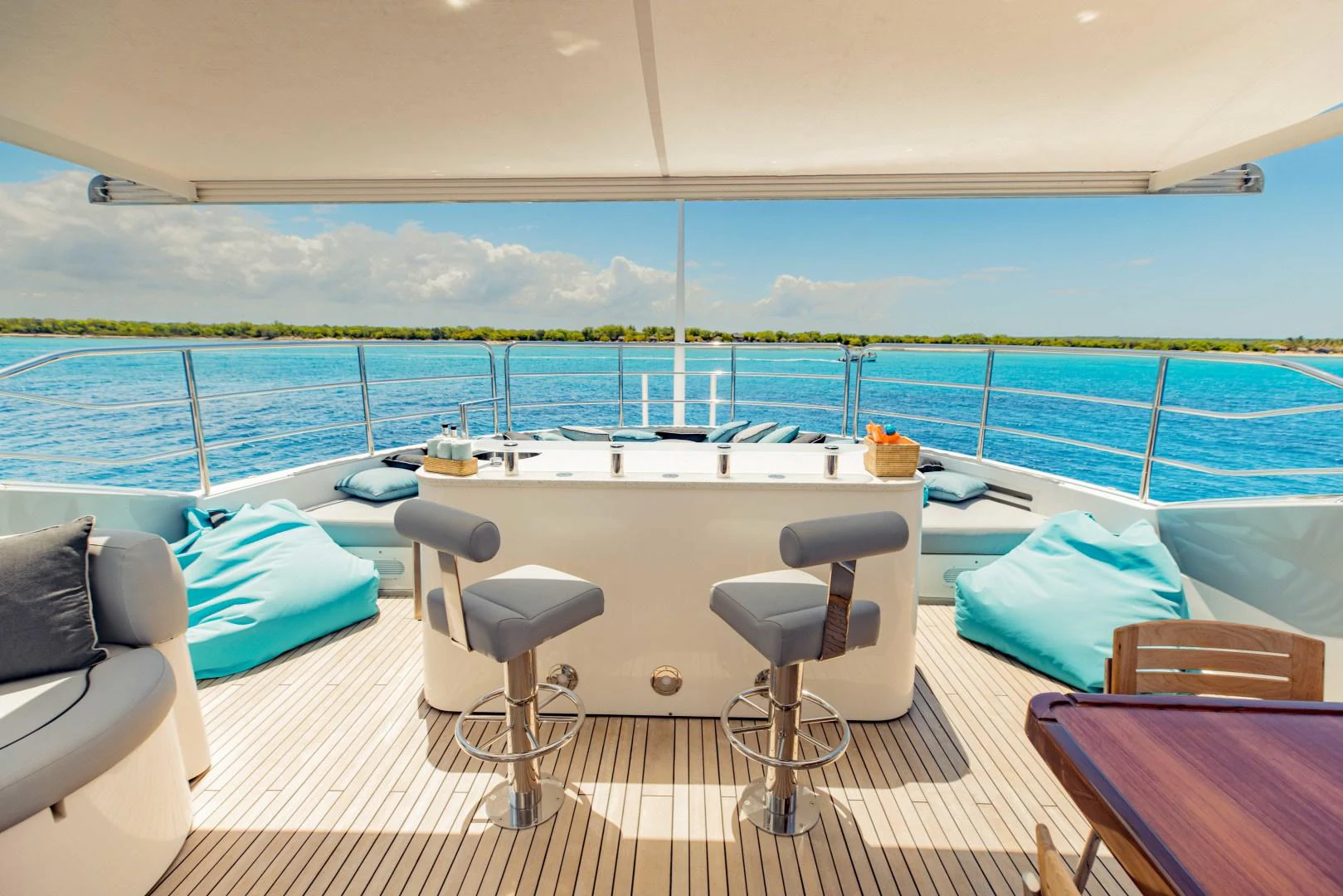a room with a table chairs and a view of the ocean aboard TAYRONA Yacht for Sale