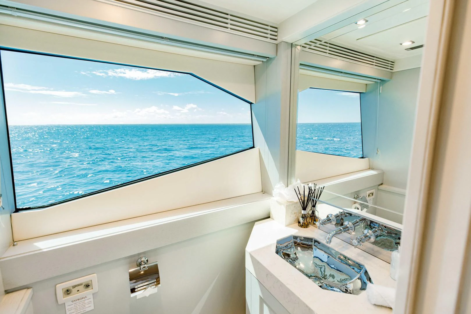 a bathroom with a large window overlooking the ocean aboard TAYRONA Yacht for Sale