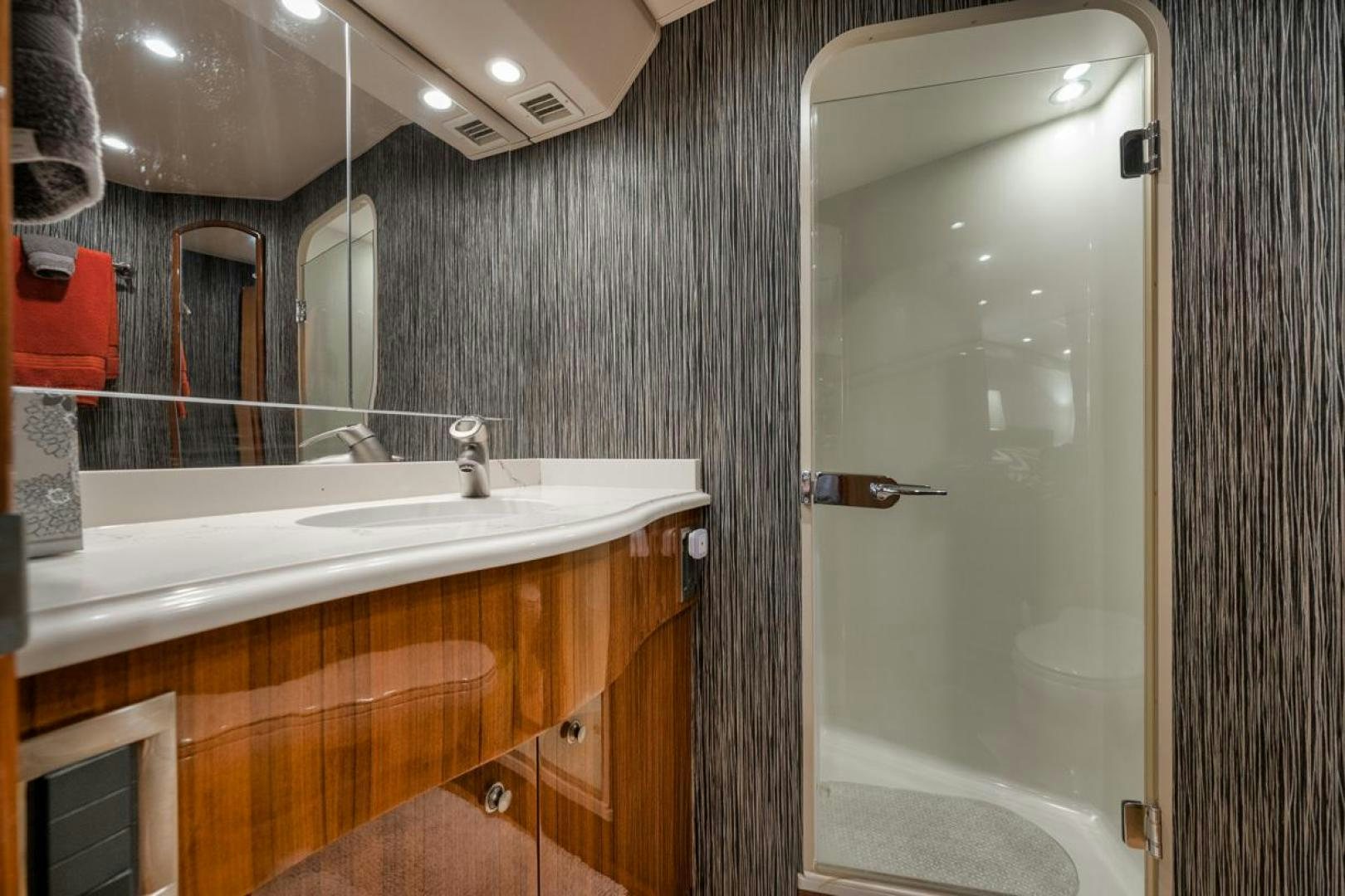 a bathroom with a sink and a mirror aboard 68 VIKING Yacht for Sale