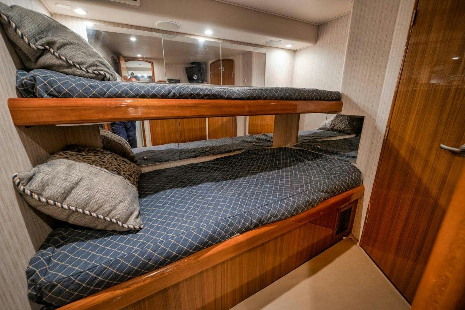 a bed with a blue comforter aboard 68 VIKING Yacht for Sale