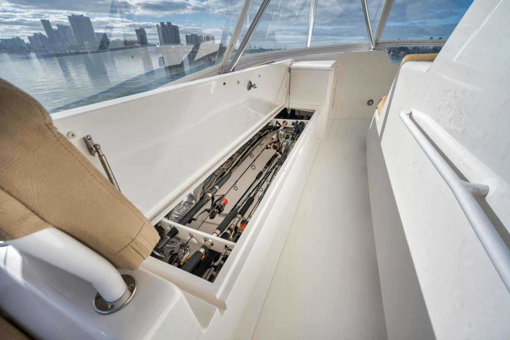 a person's hand holding a phone and a picture of a ship aboard 68 VIKING Yacht for Sale