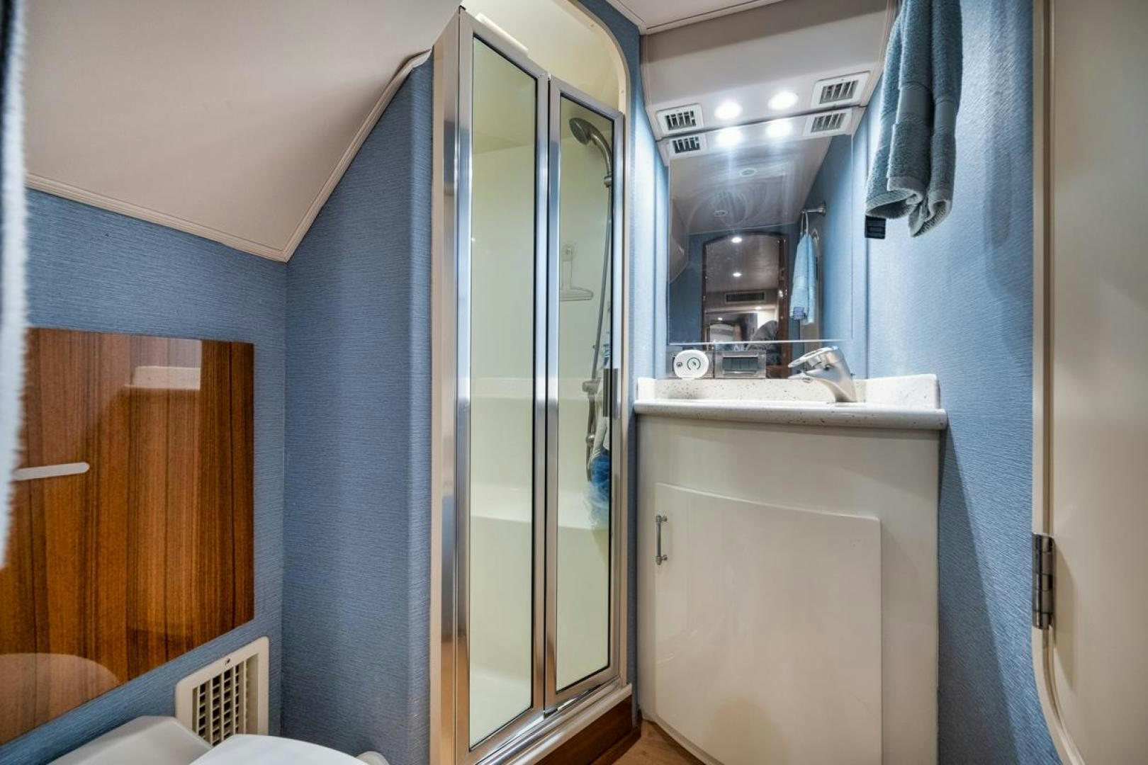 a bathroom with a glass shower aboard 68 VIKING Yacht for Sale