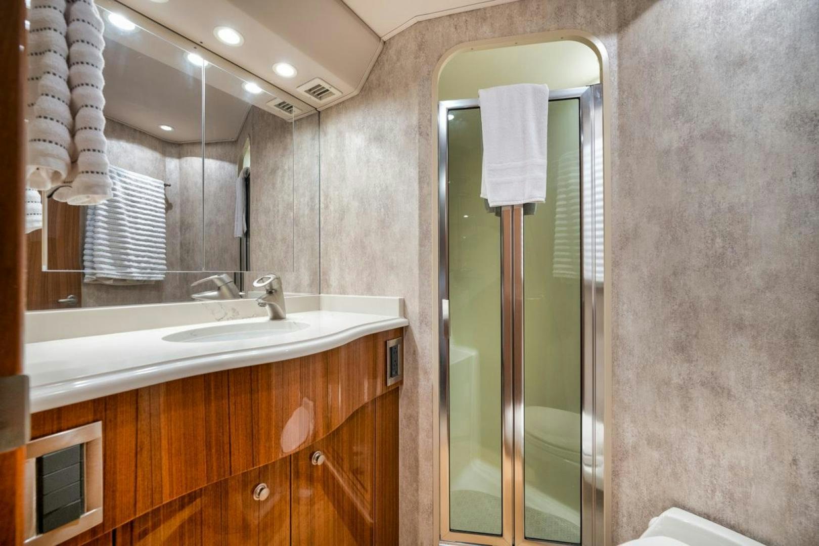 a bathroom with a glass shower aboard 68 VIKING Yacht for Sale