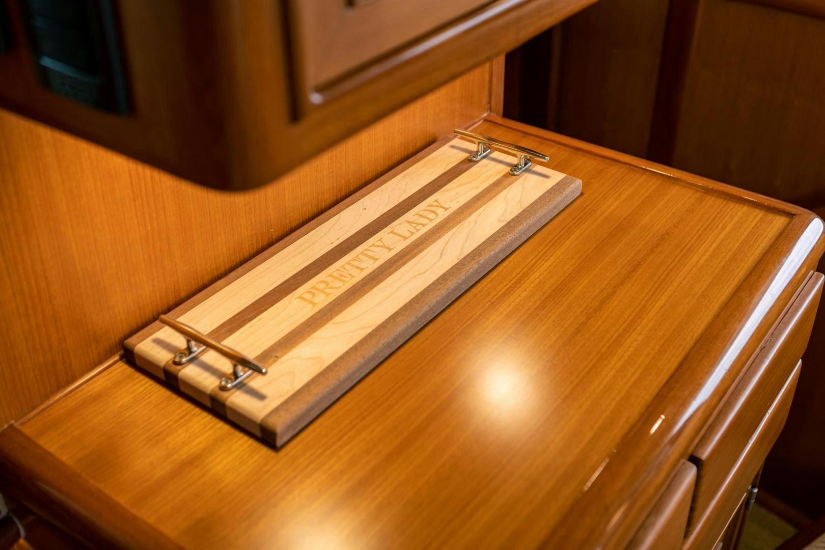 a wooden piano with a light on it aboard PRETTY LADY Yacht for Sale