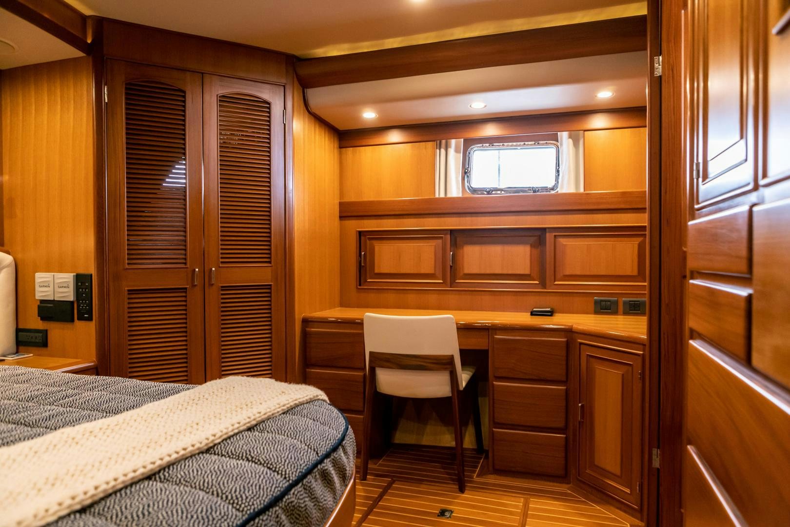 a bedroom with a bed and desk aboard PRETTY LADY Yacht for Sale