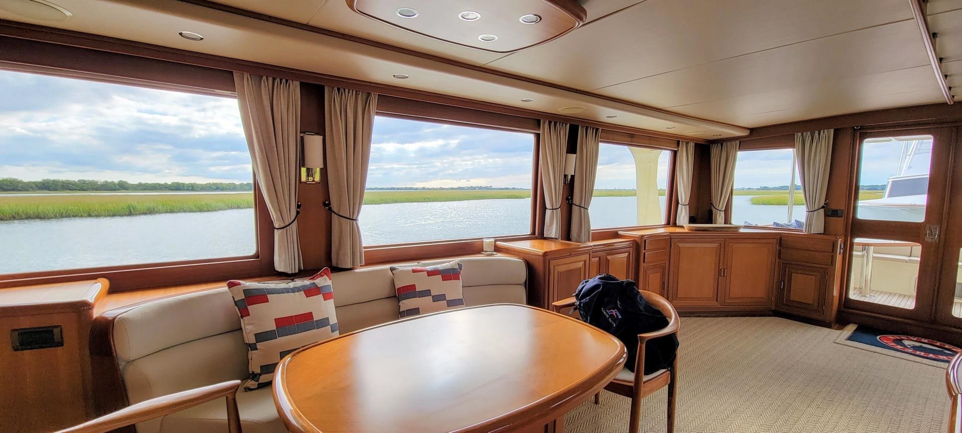 a large room with a table and chairs aboard PRETTY LADY Yacht for Sale