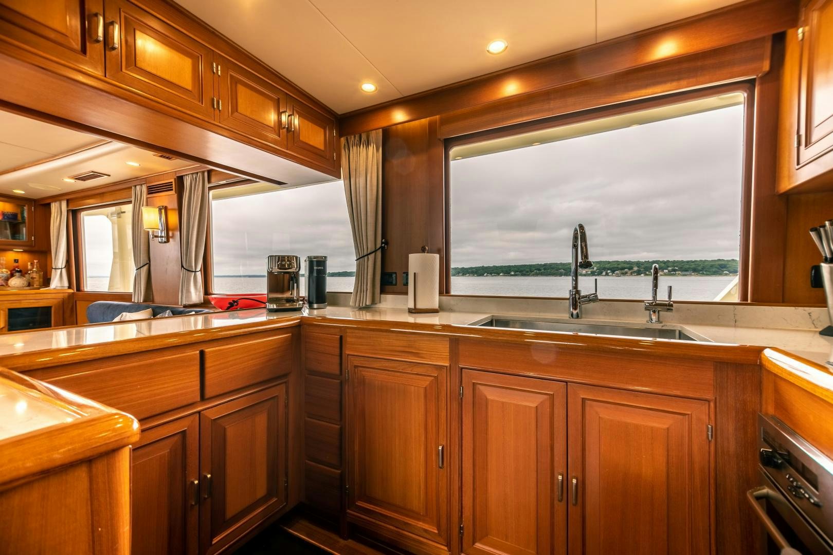a kitchen with wooden cabinets aboard PRETTY LADY Yacht for Sale