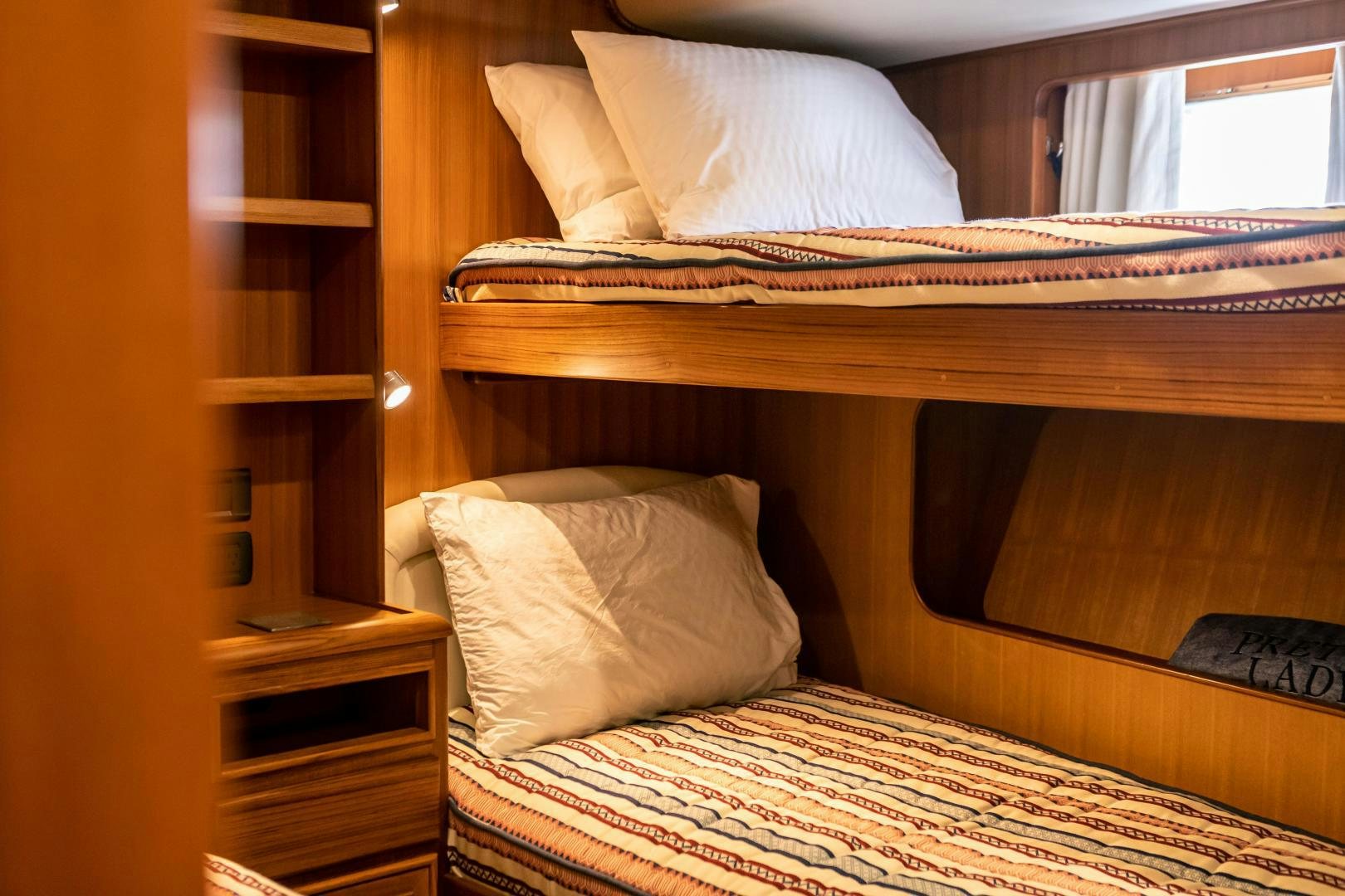 a bed with white sheets aboard PRETTY LADY Yacht for Sale