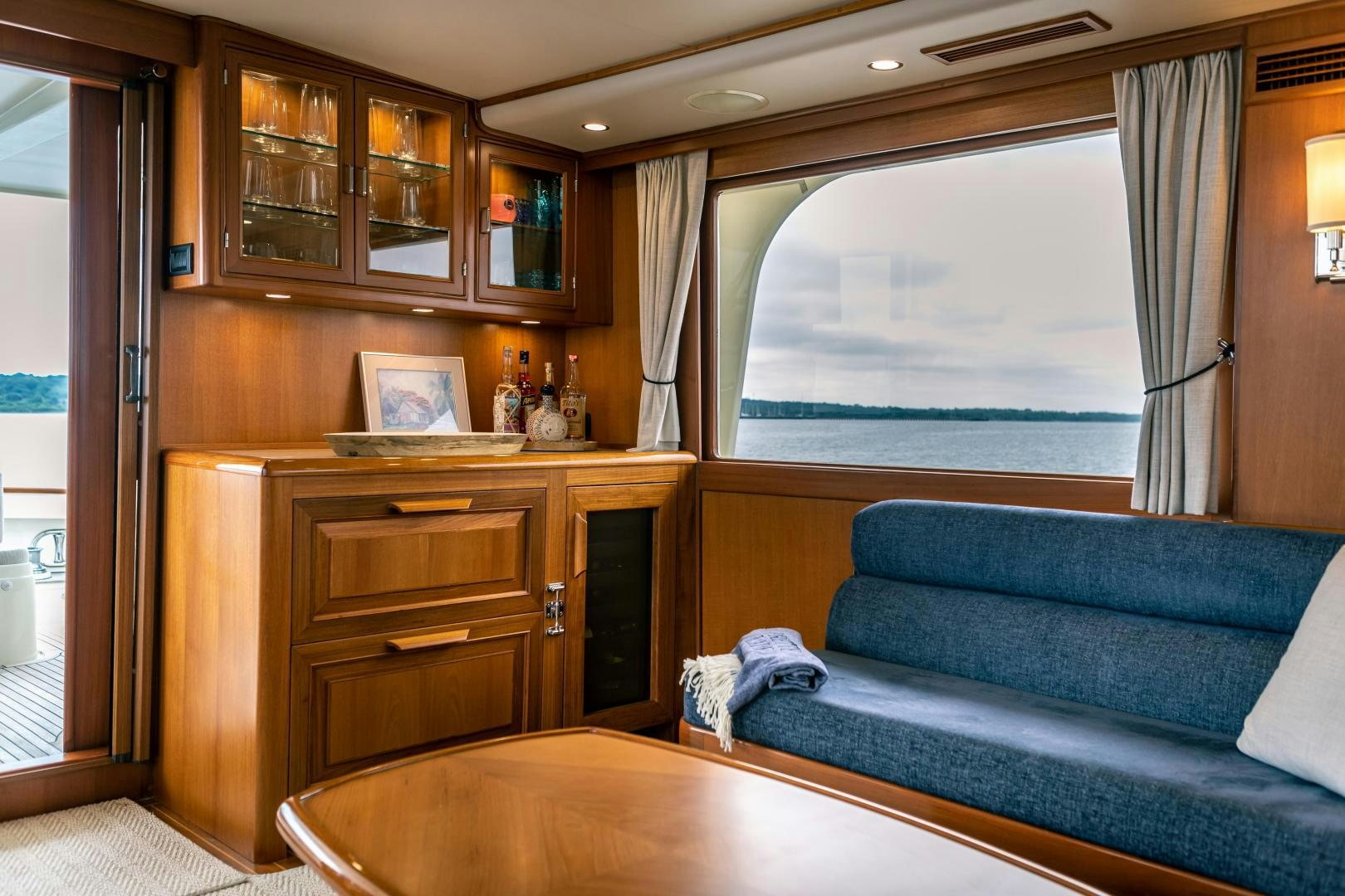 a living room with a couch and a window aboard PRETTY LADY Yacht for Sale