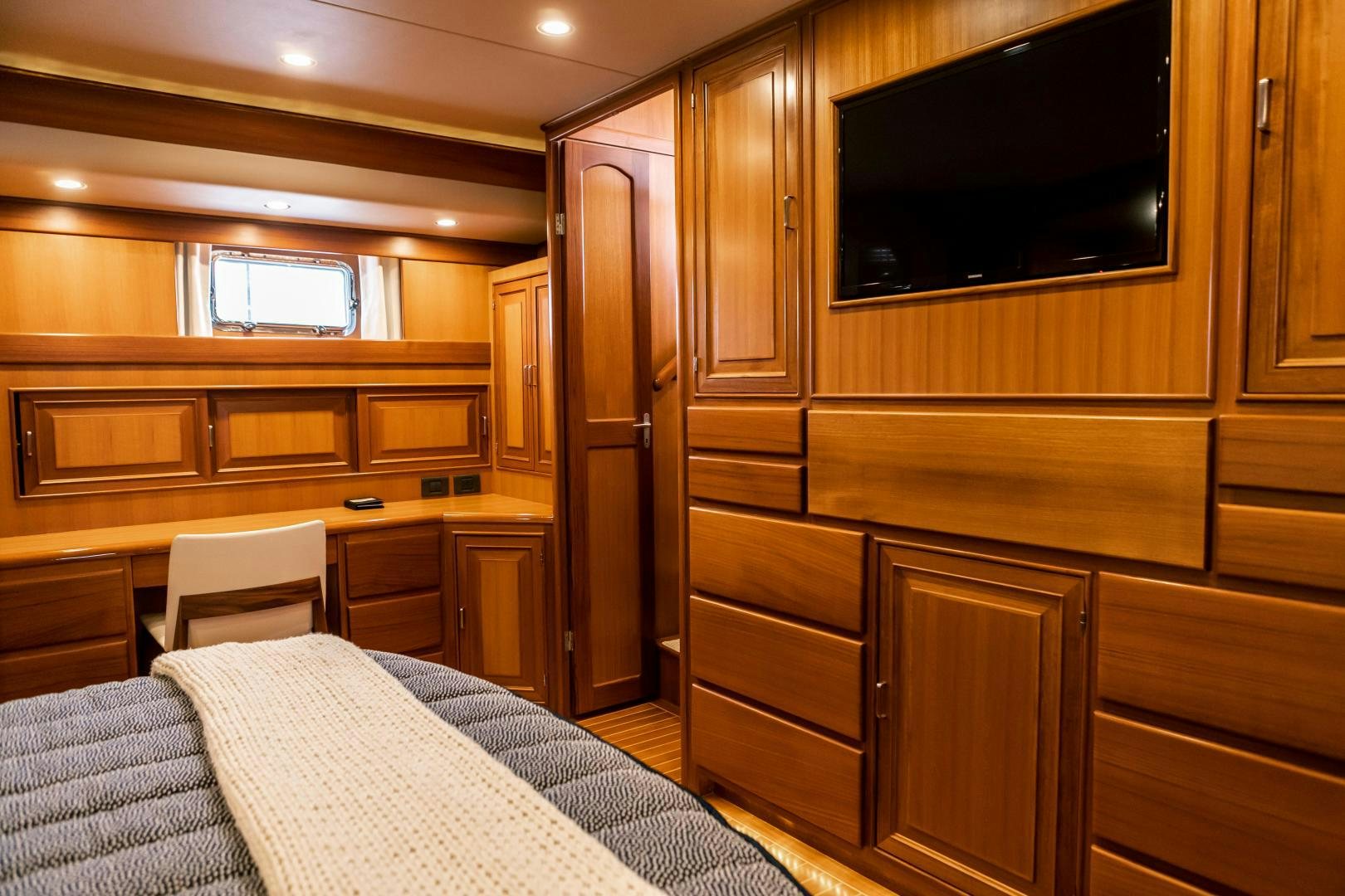 a bedroom with a bed and a tv aboard PRETTY LADY Yacht for Sale
