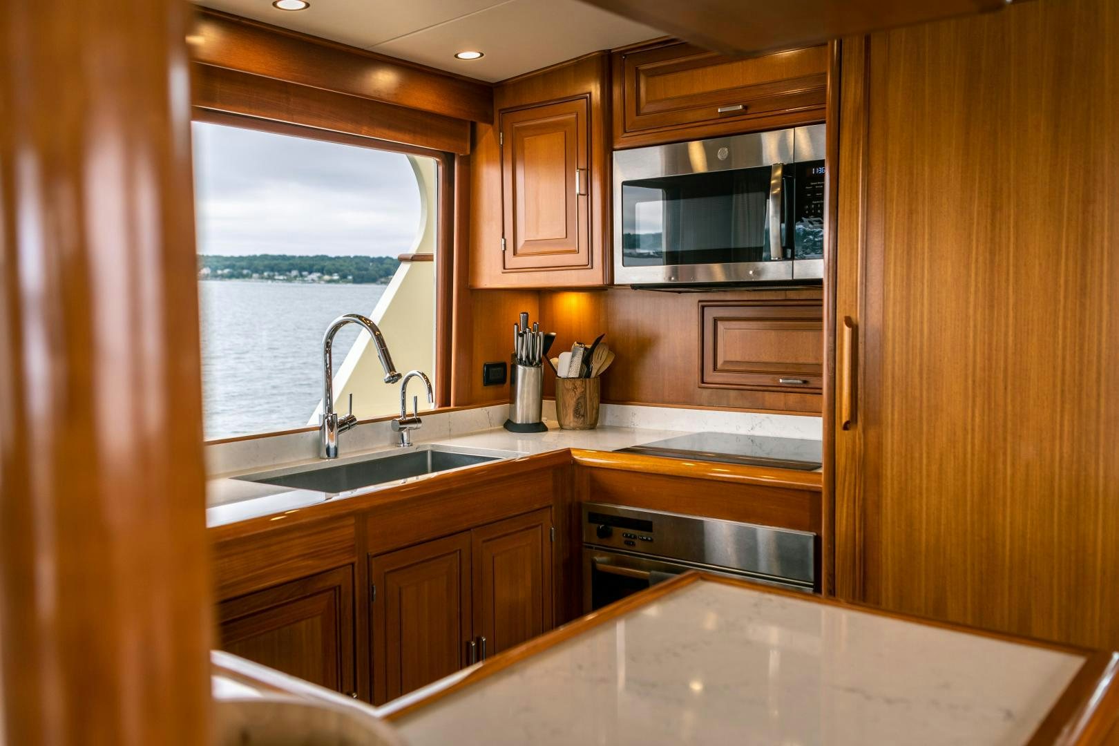 a kitchen with wooden cabinets aboard PRETTY LADY Yacht for Sale