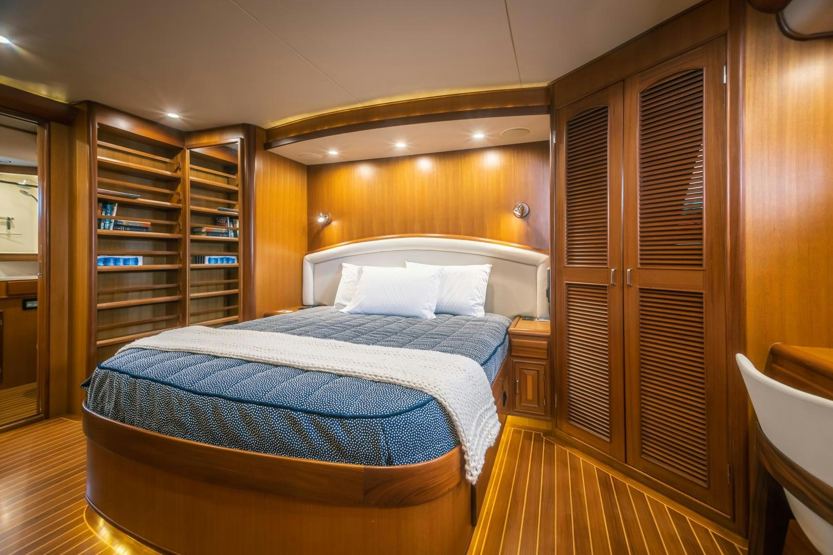 a bedroom with a bed and a closet aboard PRETTY LADY Yacht for Sale