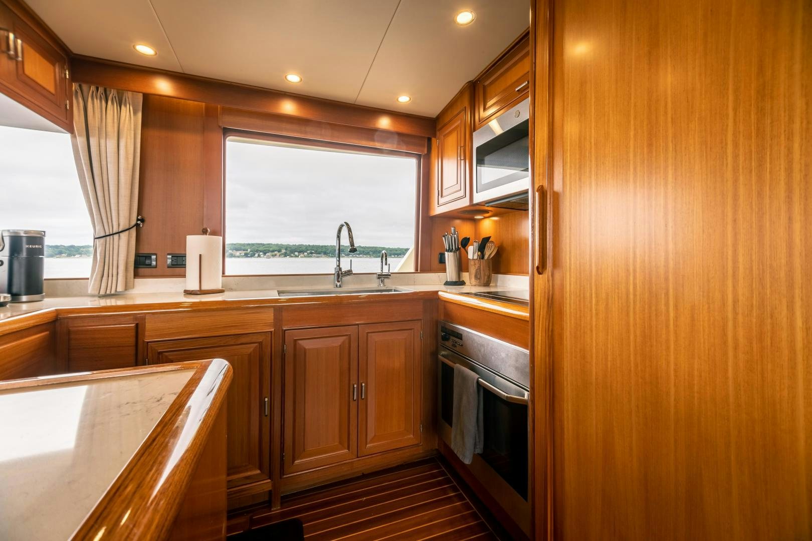 a kitchen with wooden cabinets aboard PRETTY LADY Yacht for Sale