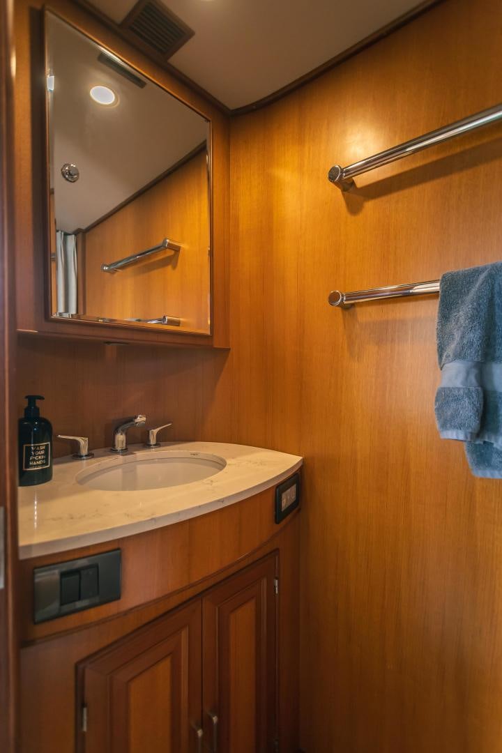a bathroom with wooden cabinets aboard PRETTY LADY Yacht for Sale
