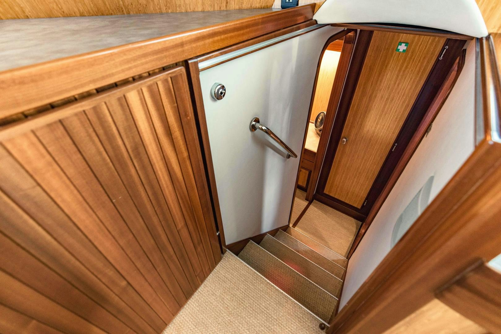 a wooden cabinet with a door aboard IETA Yacht for Sale