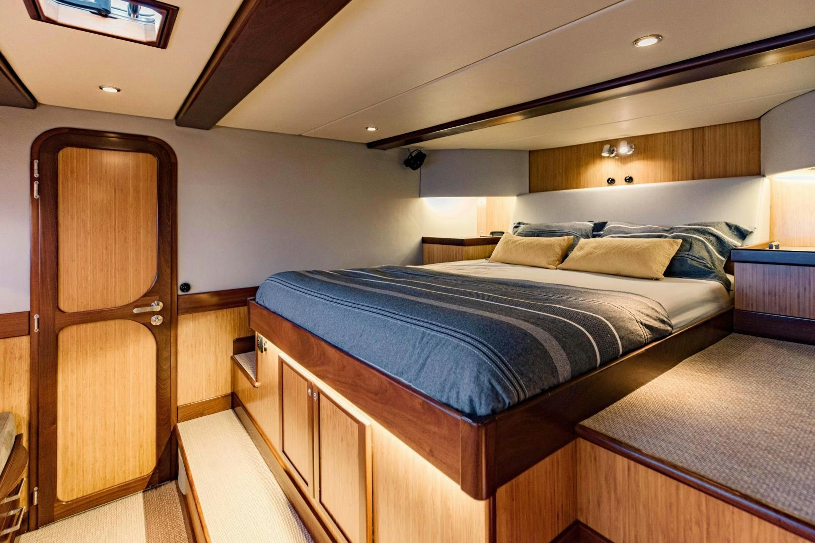 a bedroom with a bed and a chair aboard IETA Yacht for Sale