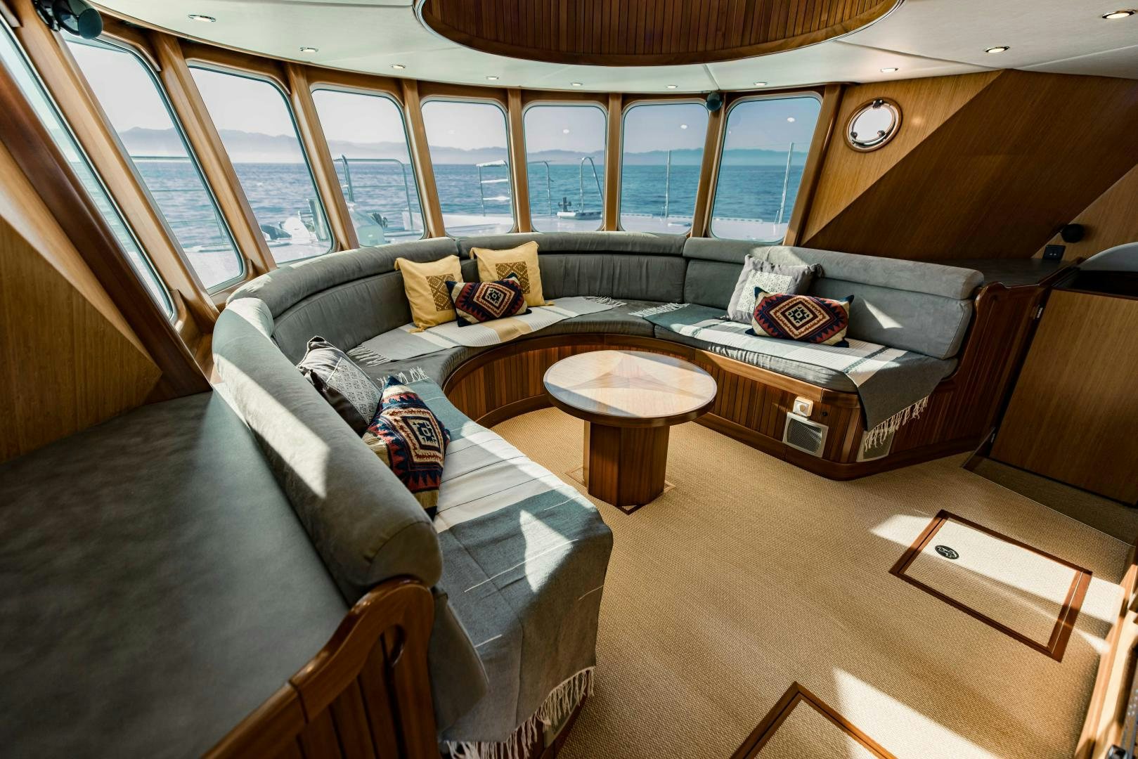 a living room with a couch and a coffee table aboard IETA Yacht for Sale