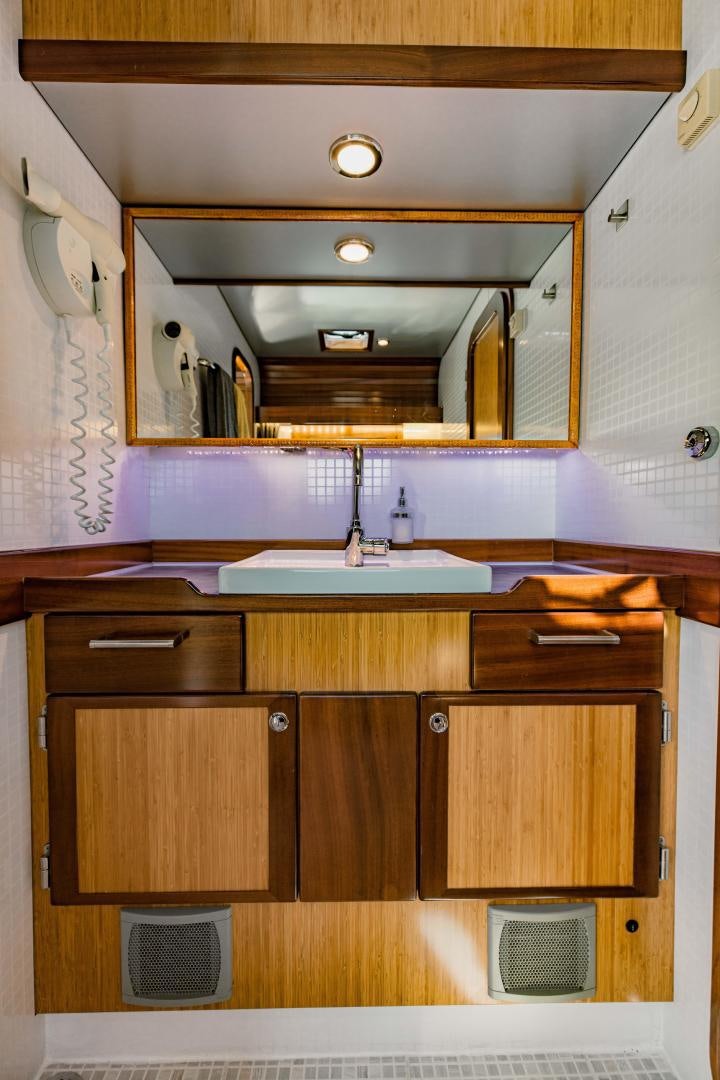 a bathroom with a sink and a mirror aboard IETA Yacht for Sale