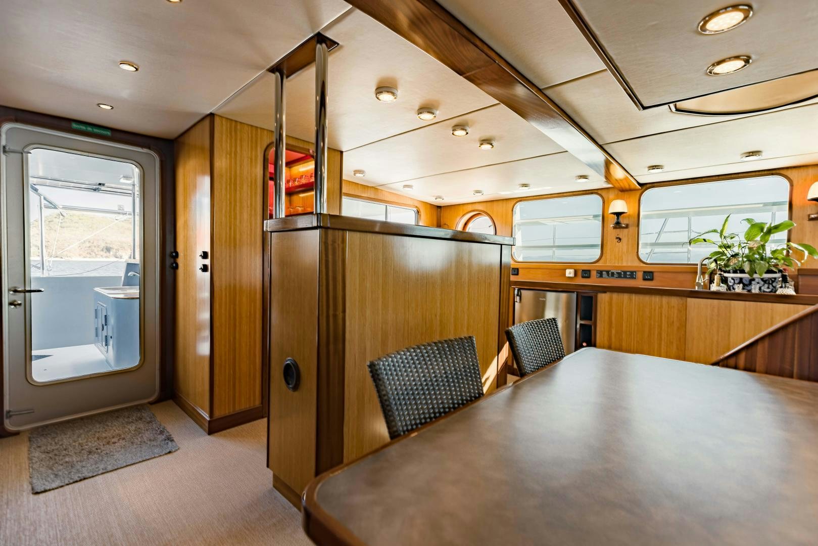 a room with a table and chairs aboard IETA Yacht for Sale