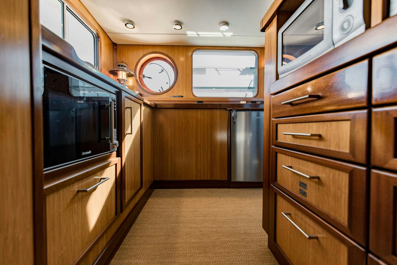 a room with wooden cabinets aboard IETA Yacht for Sale