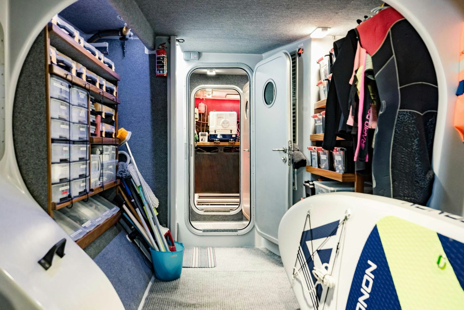a room with a closet and clothes on the wall aboard IETA Yacht for Sale