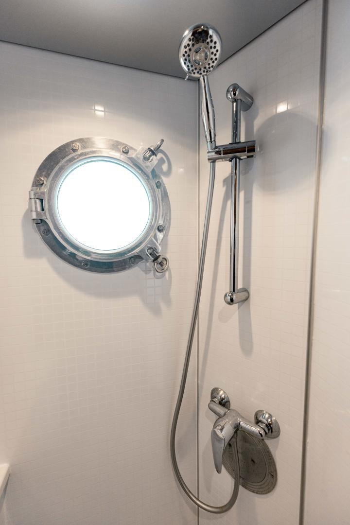 a shower with a round mirror aboard IETA Yacht for Sale