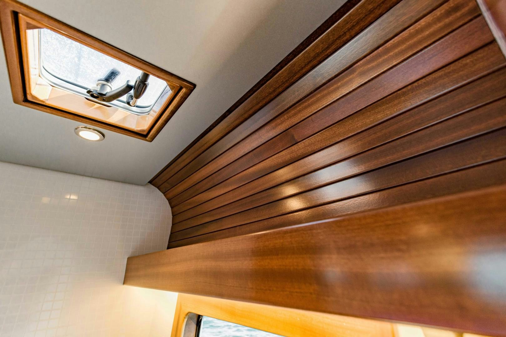 a wooden shelf with a mirror aboard IETA Yacht for Sale