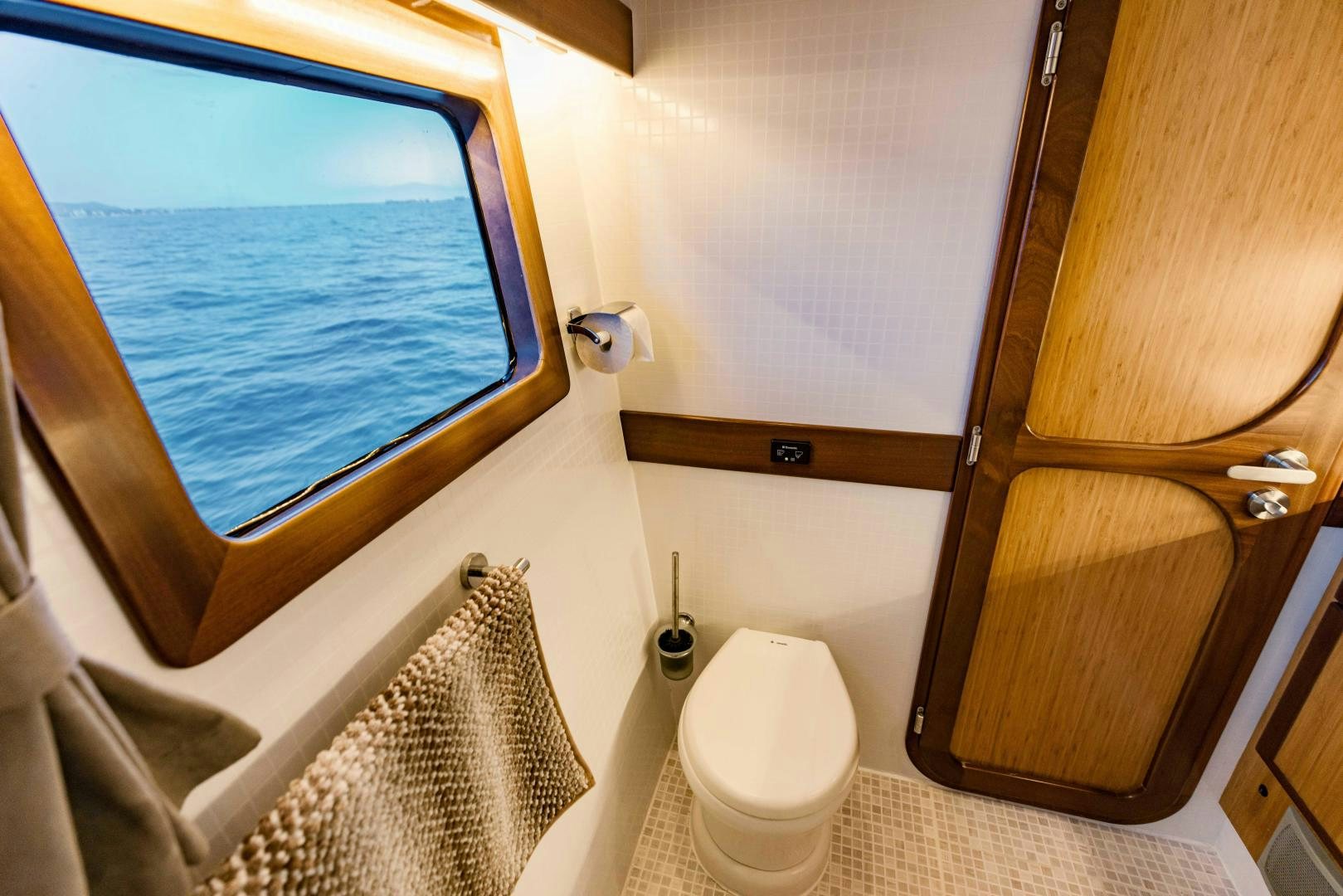 a bathroom with a window and a toilet aboard IETA Yacht for Sale