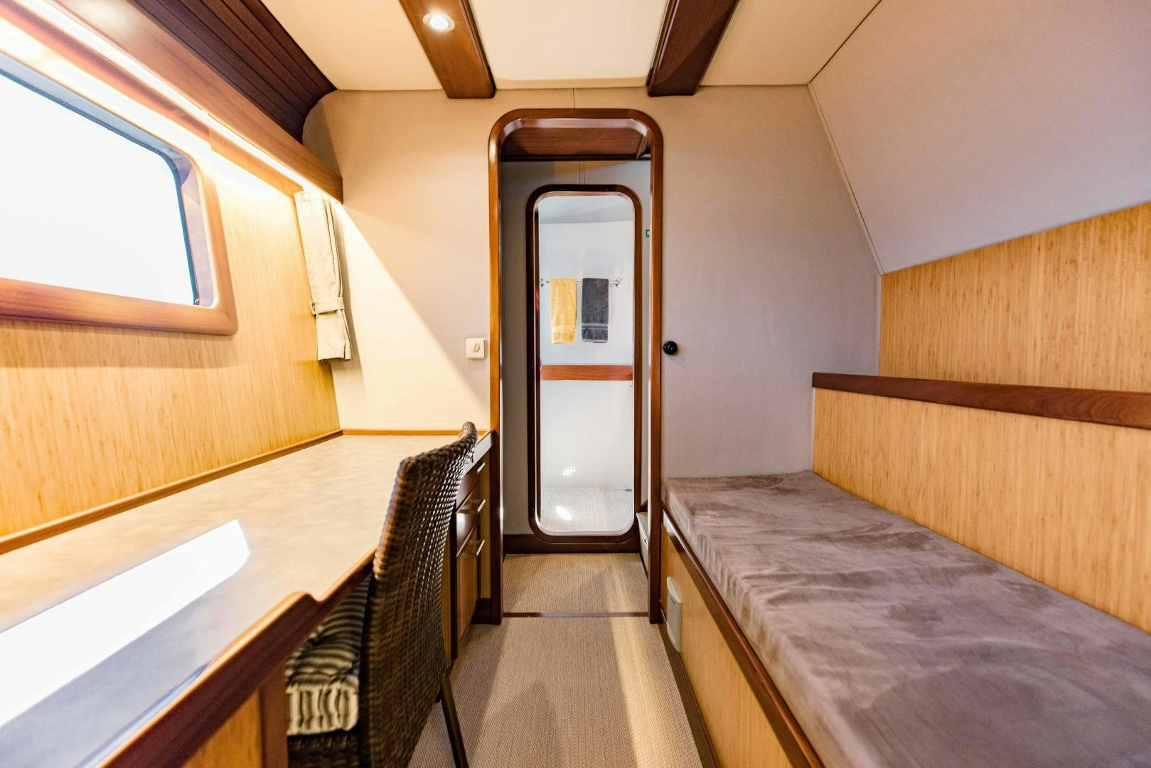 a room with a bed and a door aboard IETA Yacht for Sale