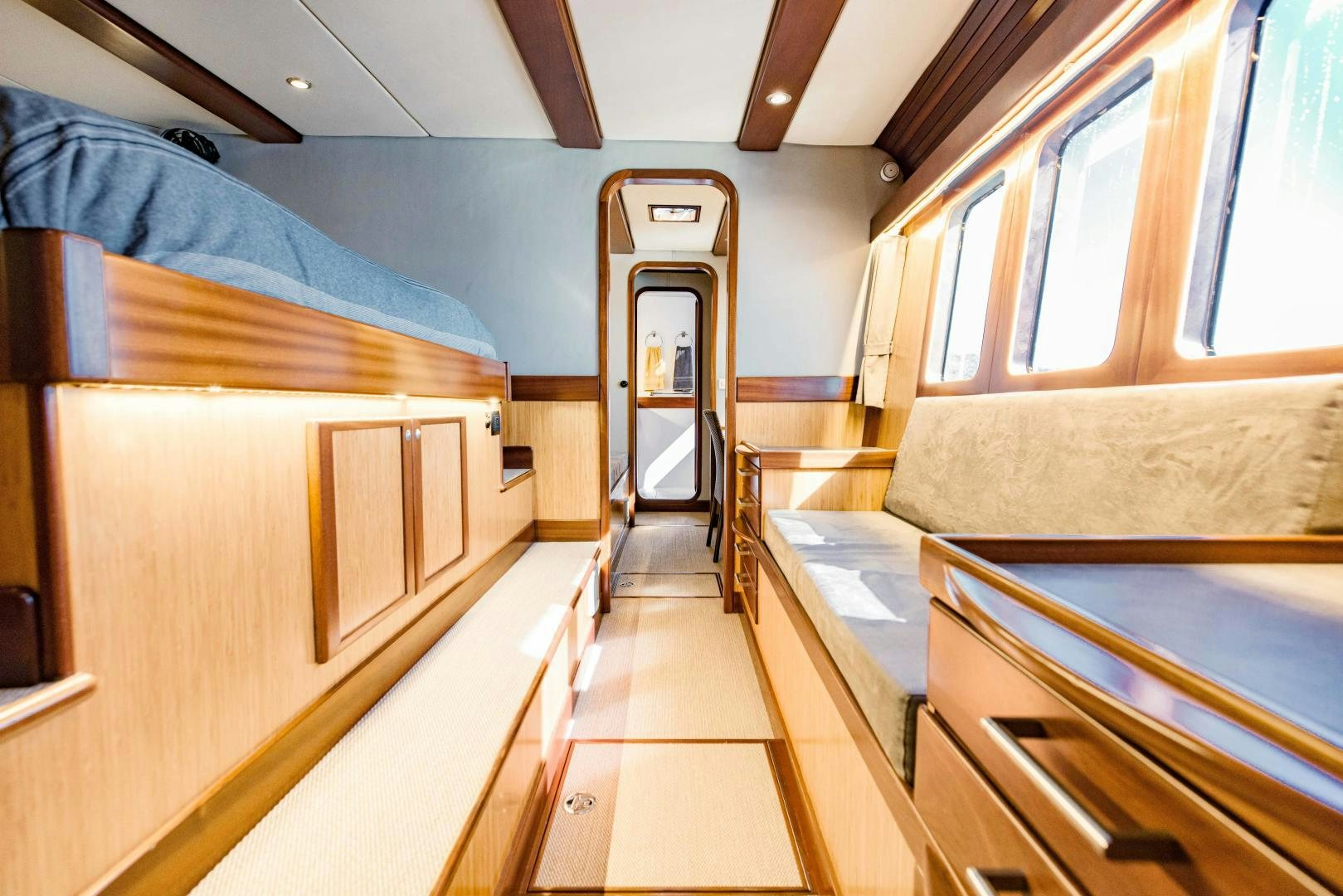 a room with wooden bunk beds aboard IETA Yacht for Sale