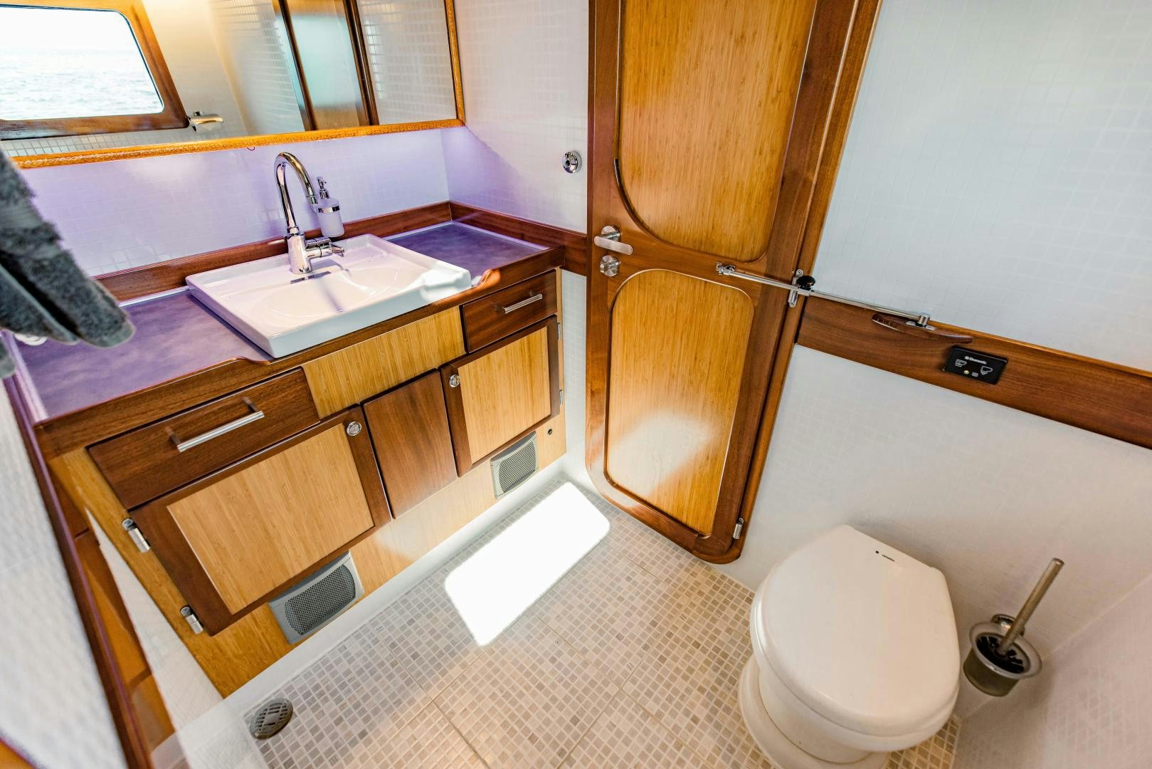 a bathroom with a toilet and a sink aboard IETA Yacht for Sale
