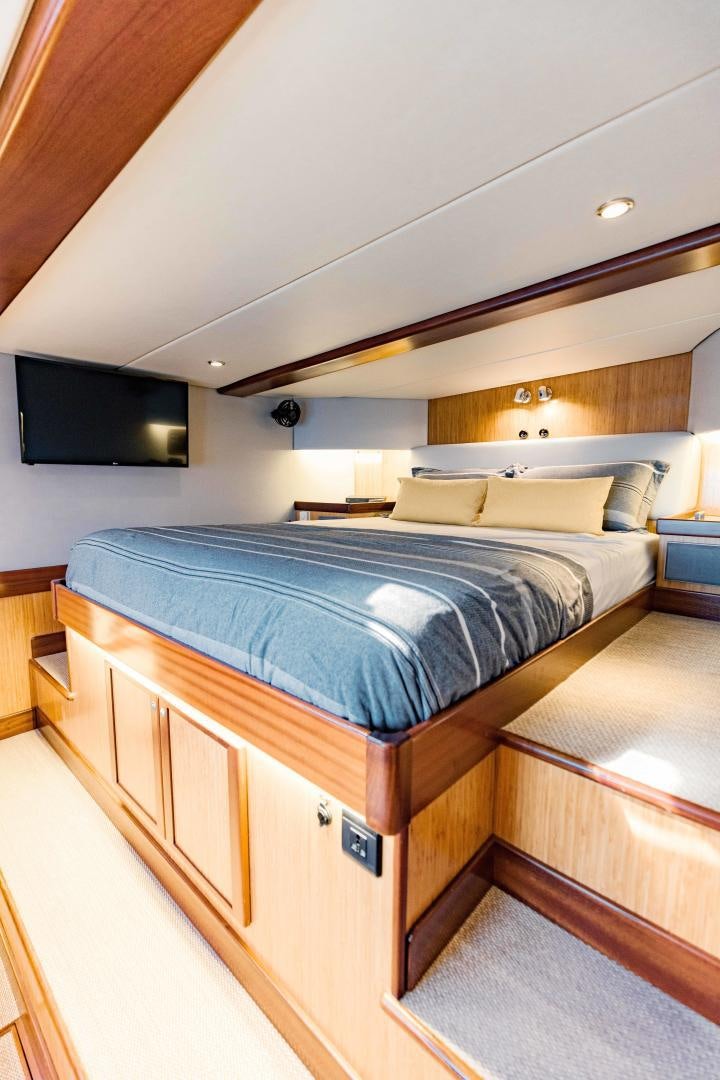 a bed with a television on the ceiling aboard IETA Yacht for Sale