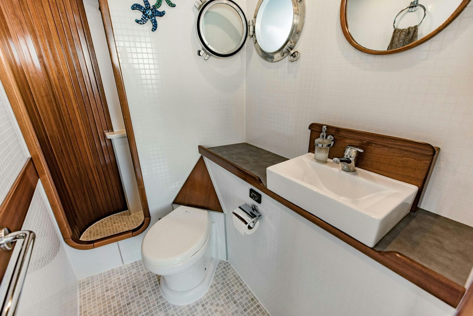 a bathroom with a sink toilet and a mirror aboard IETA Yacht for Sale