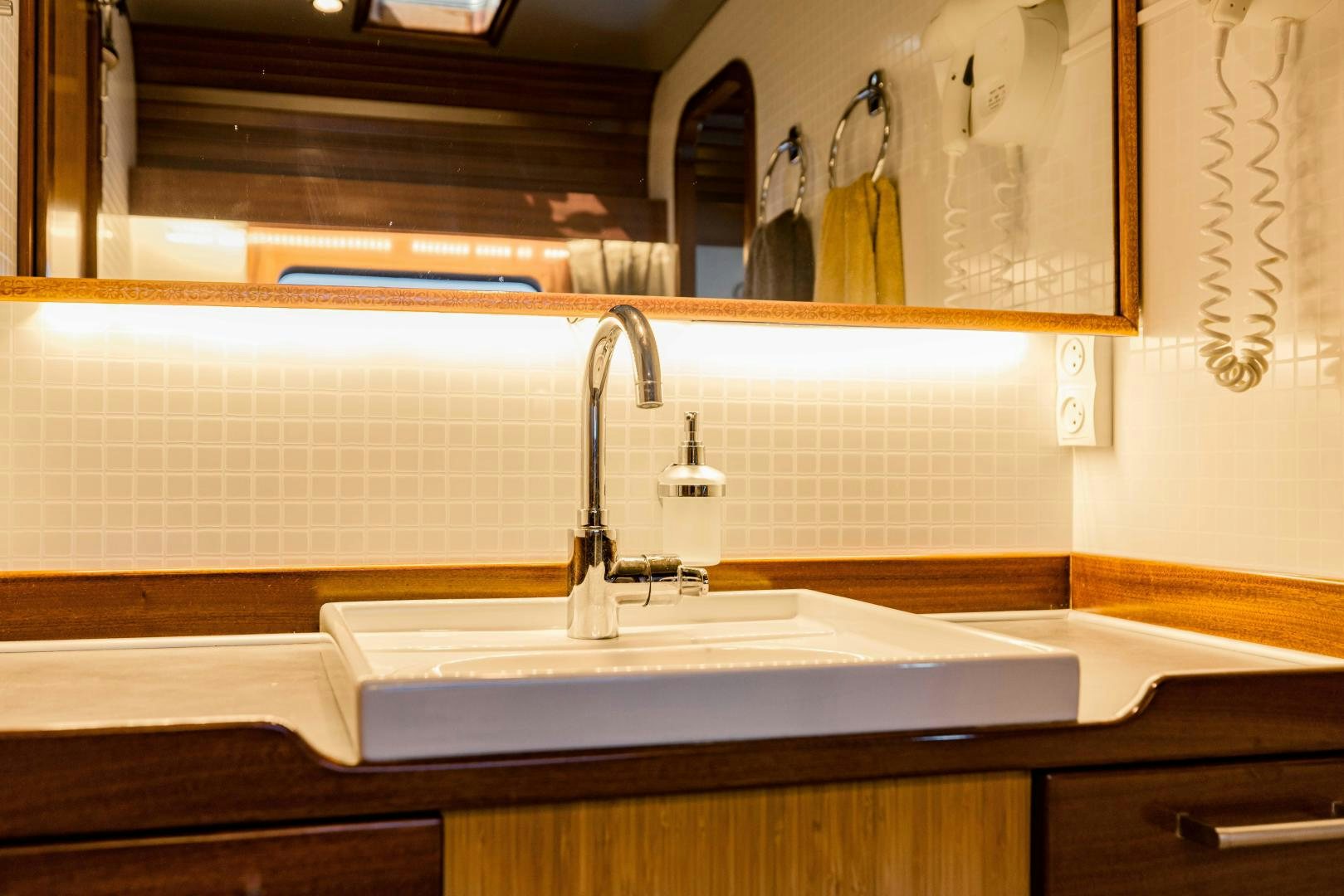 a bathroom with a large mirror aboard IETA Yacht for Sale