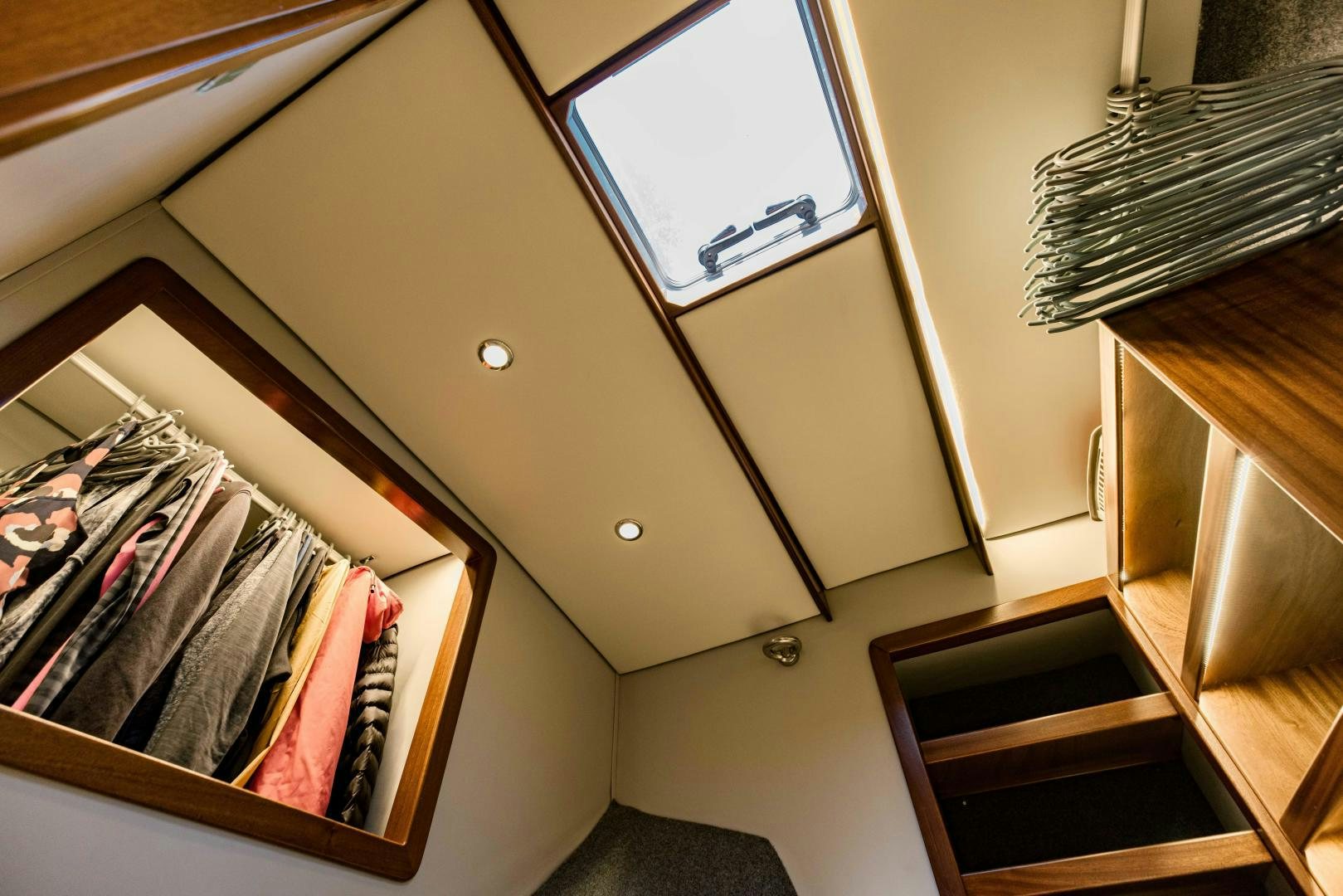 a closet with clothes on the wall aboard IETA Yacht for Sale