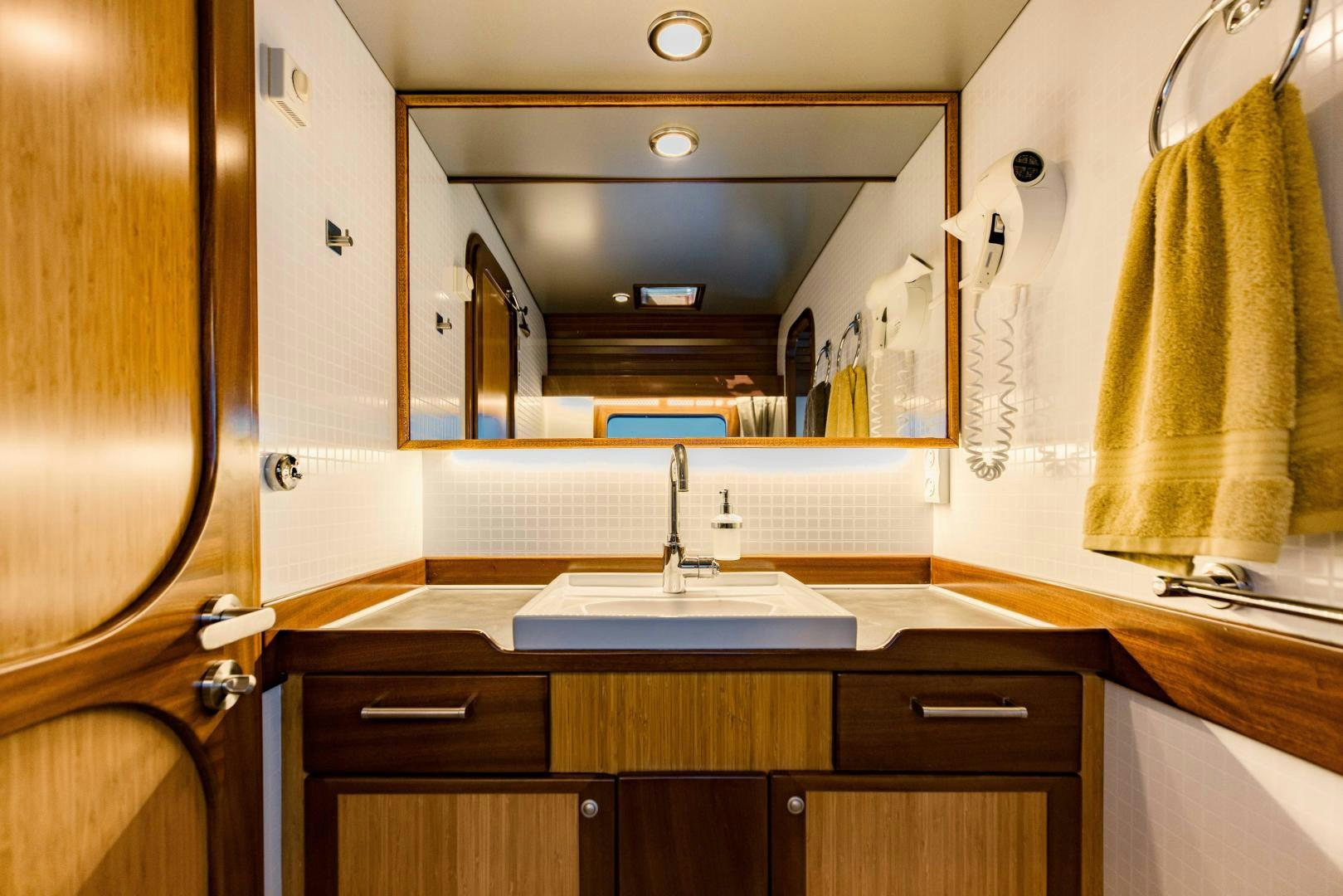 a bathroom with a large mirror aboard IETA Yacht for Sale