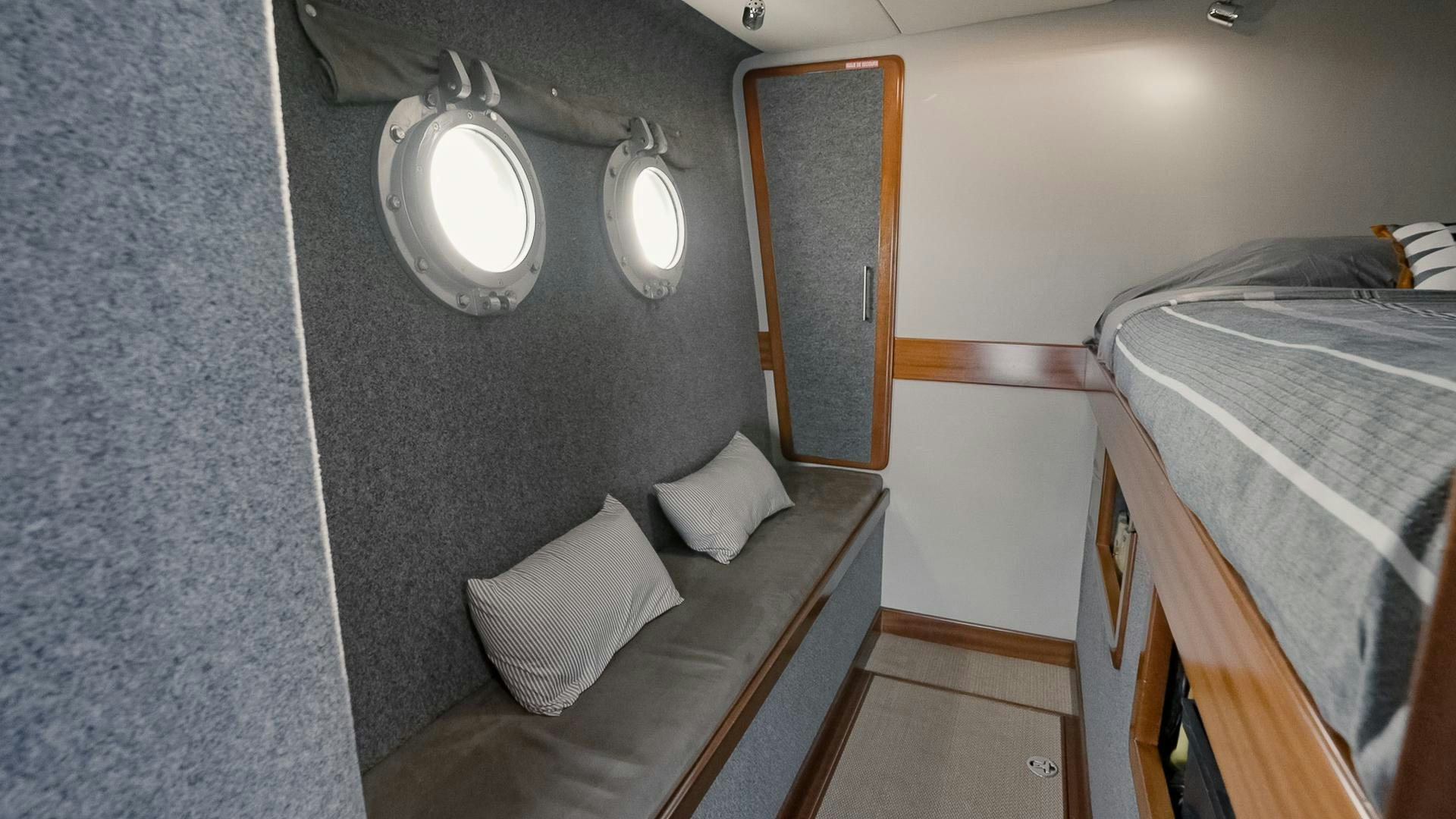 a small room with a bed and a chair aboard IETA Yacht for Sale