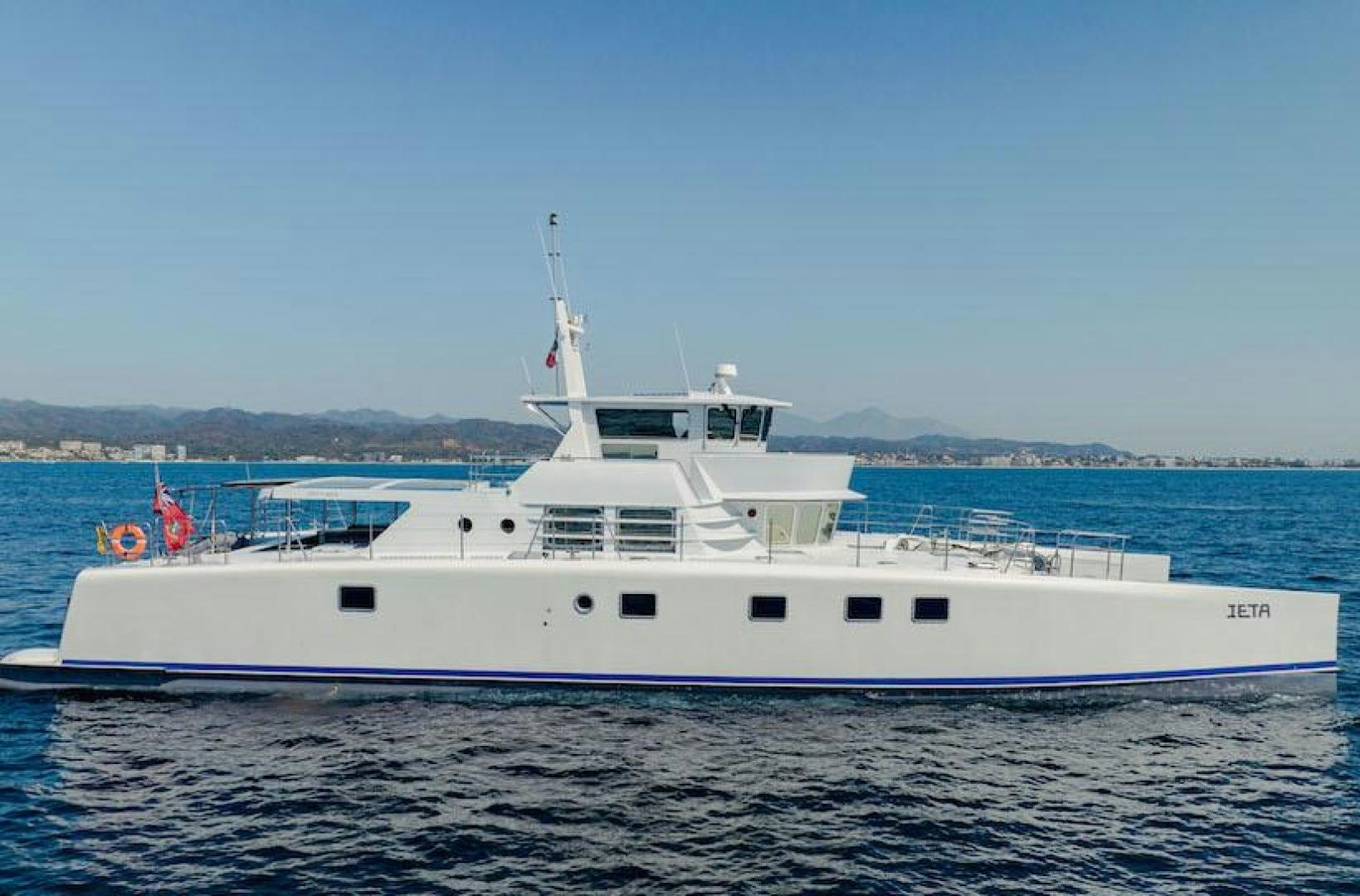 a white boat in the water aboard IETA Yacht for Sale