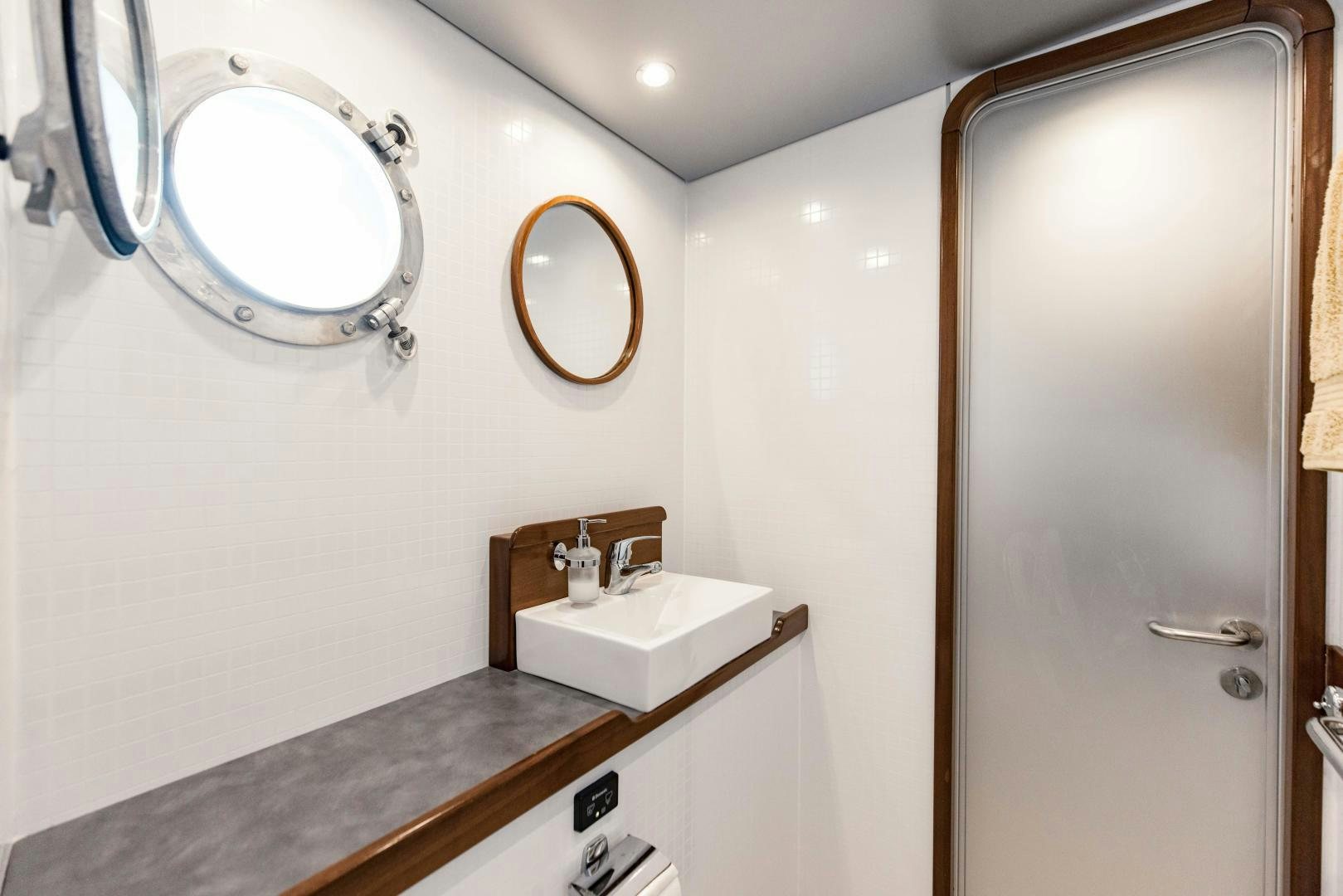 a bathroom with a mirror and a sink aboard IETA Yacht for Sale