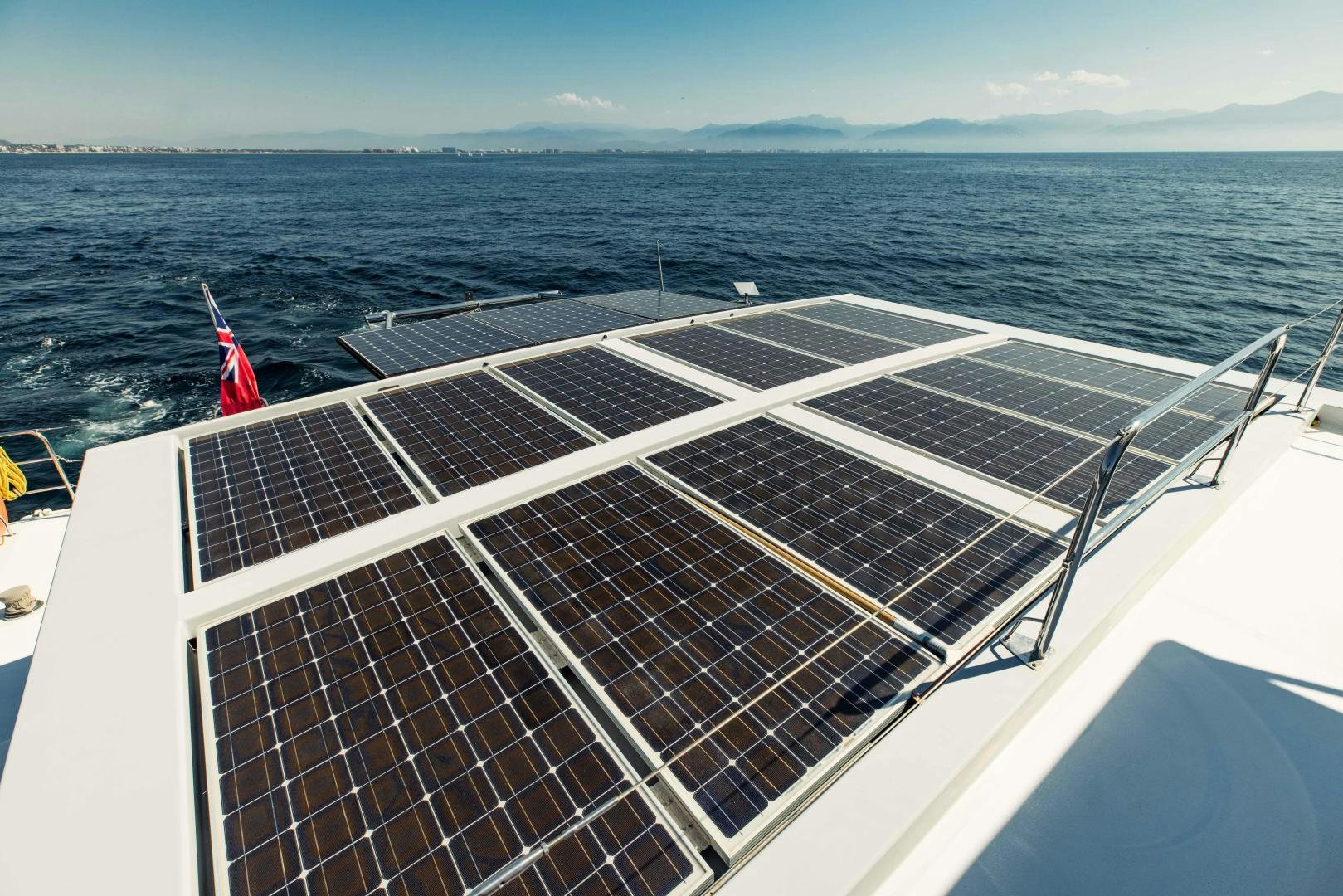 a deck of a boat with a red flag on the front aboard IETA Yacht for Sale