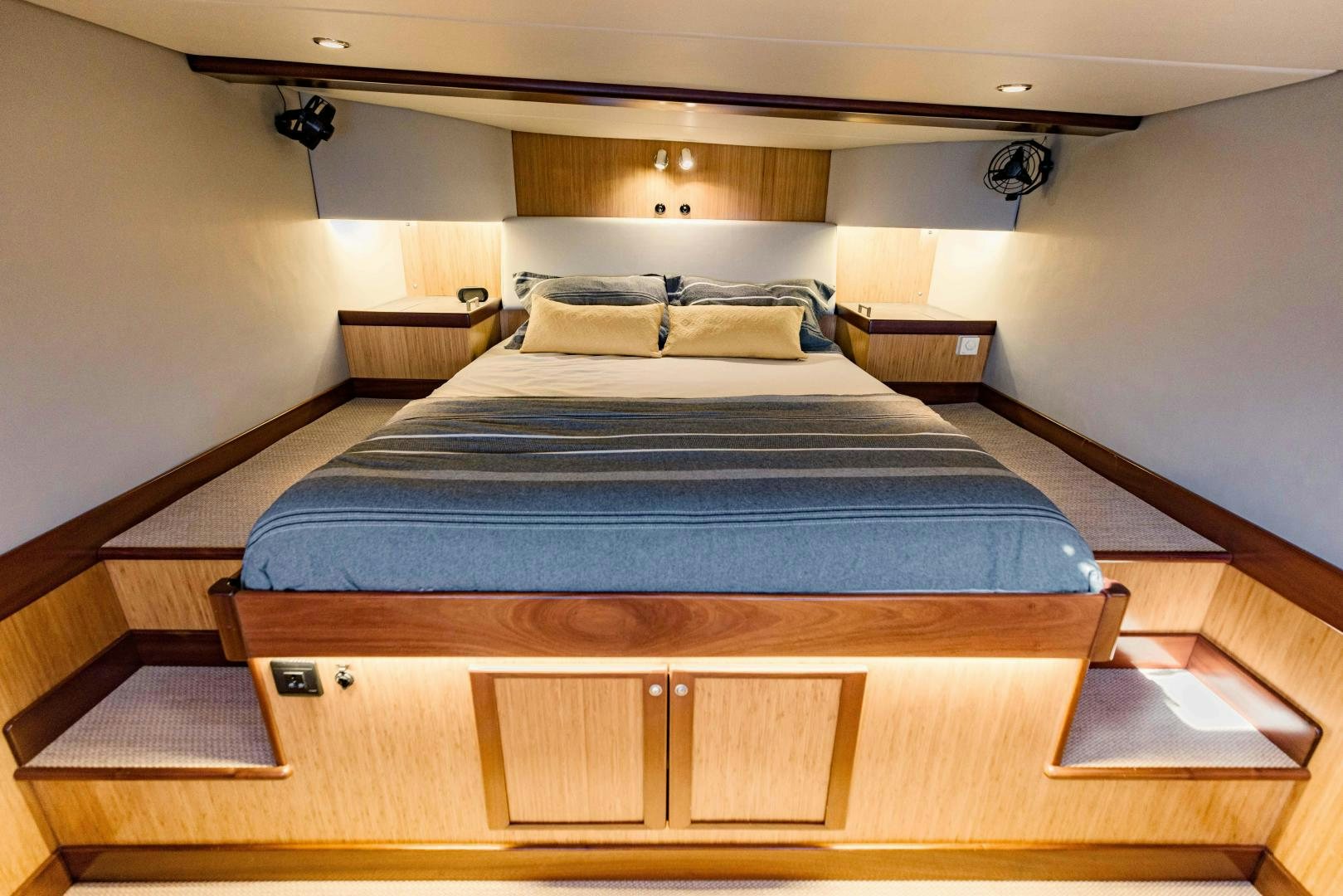 a bed with a blue sheet aboard IETA Yacht for Sale