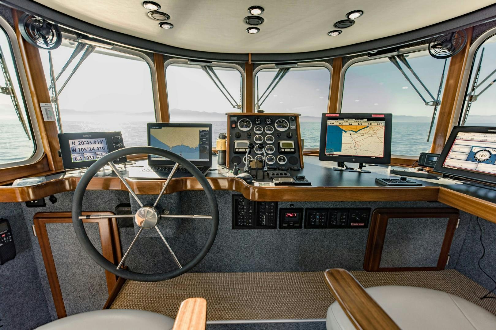 a cockpit with a large wheel aboard IETA Yacht for Sale