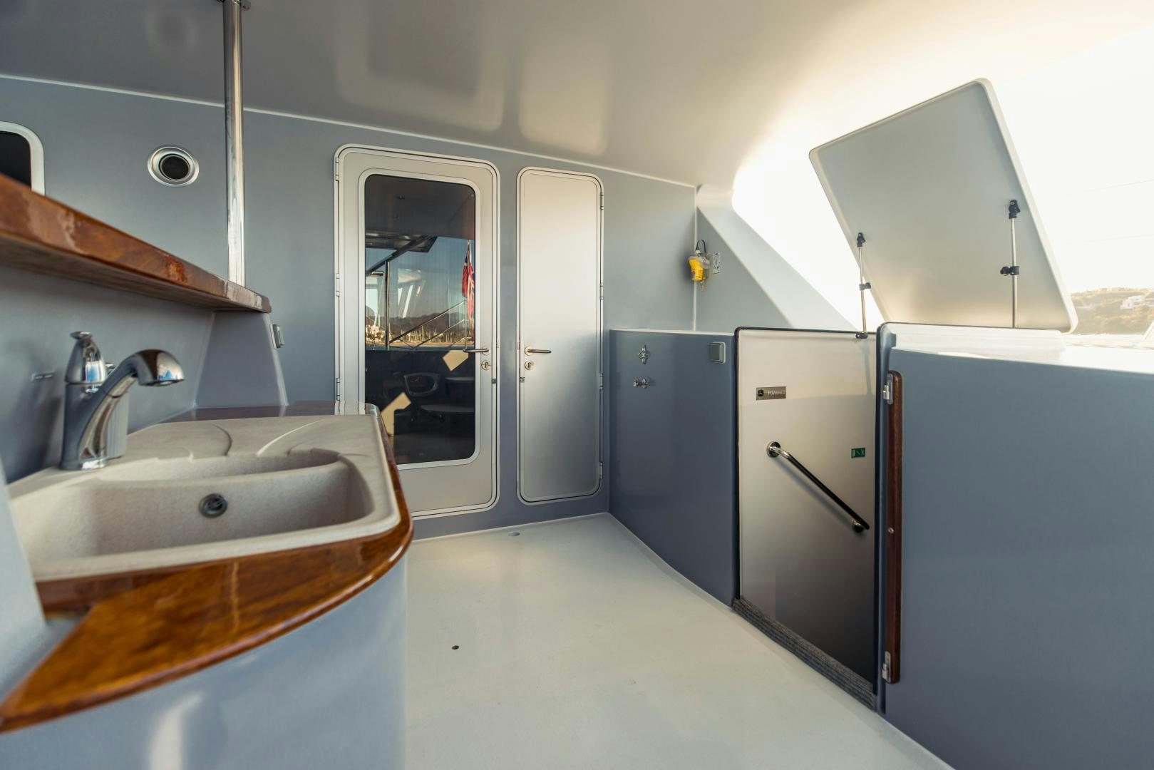 a kitchen with a sink and refrigerator aboard IETA Yacht for Sale