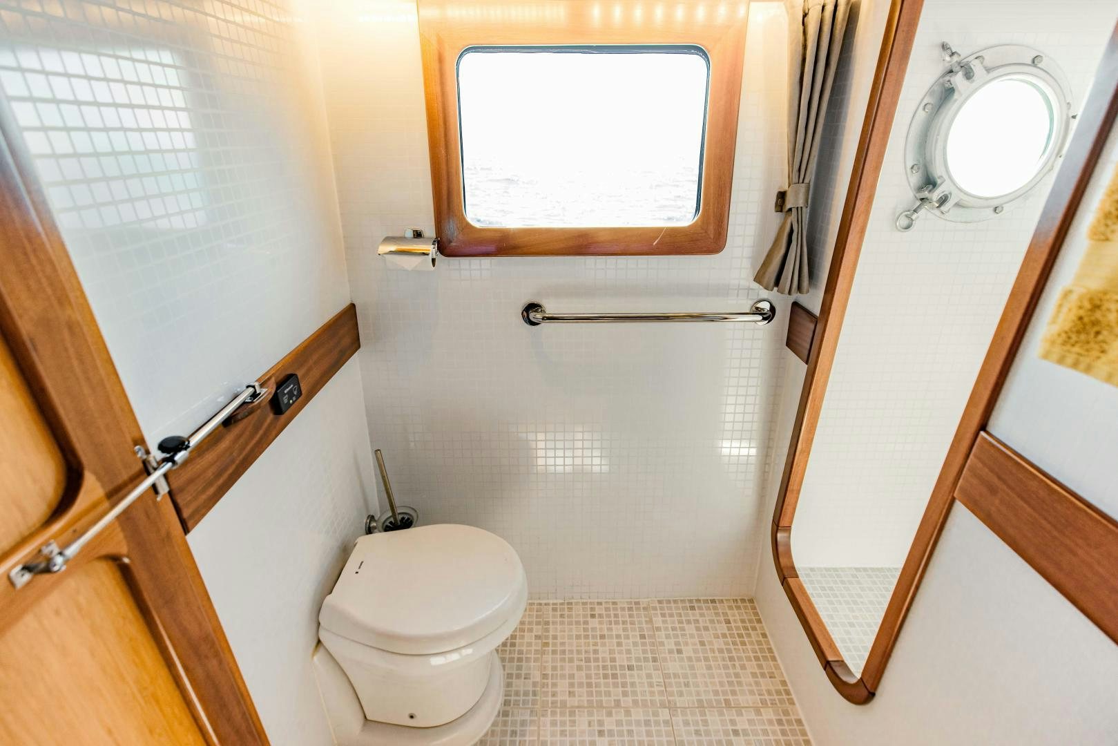 a bathroom with a toilet and a mirror aboard IETA Yacht for Sale