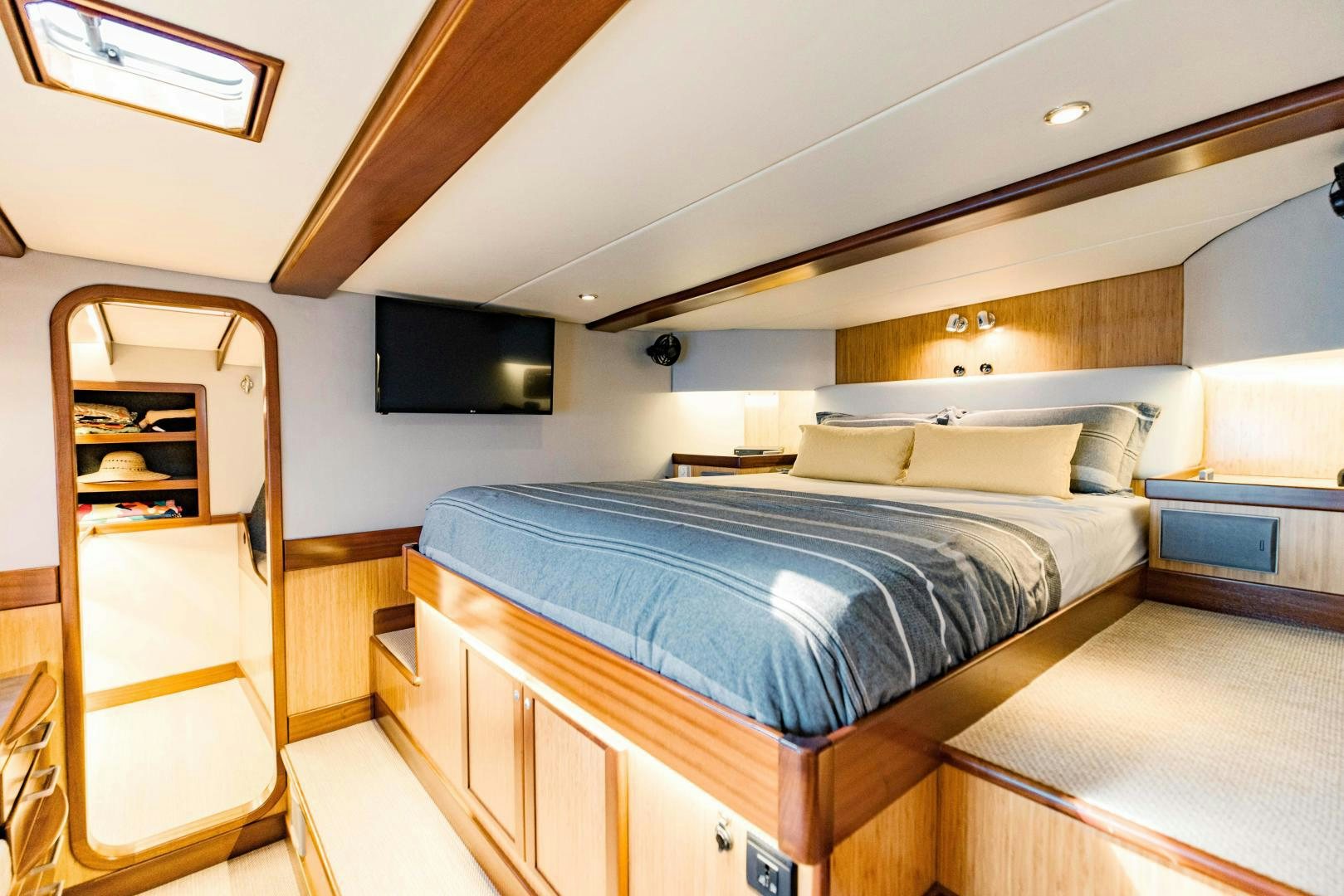 a bedroom with a bed and a tv aboard IETA Yacht for Sale