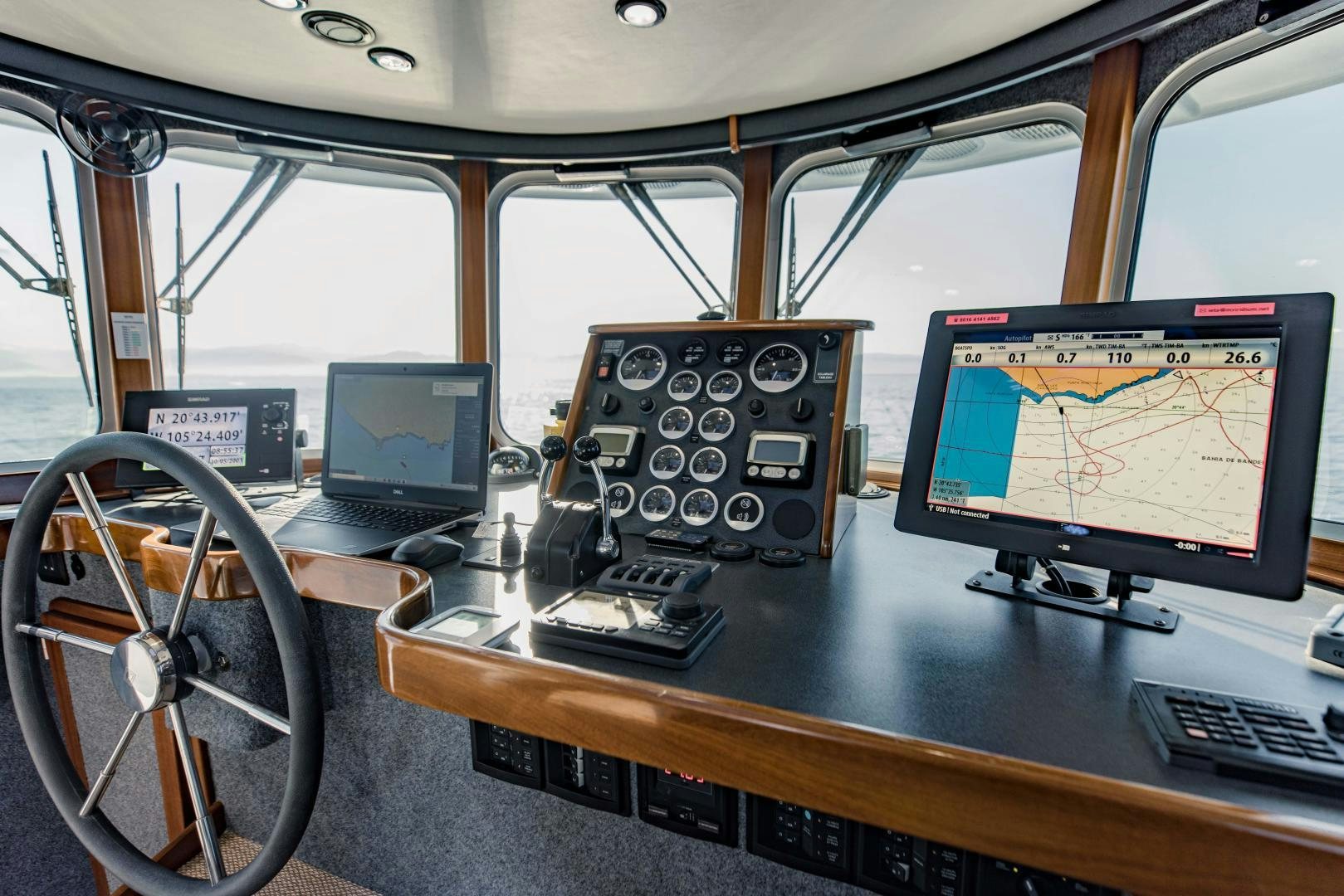 a desk with a laptop and a desktop computer on it aboard IETA Yacht for Sale