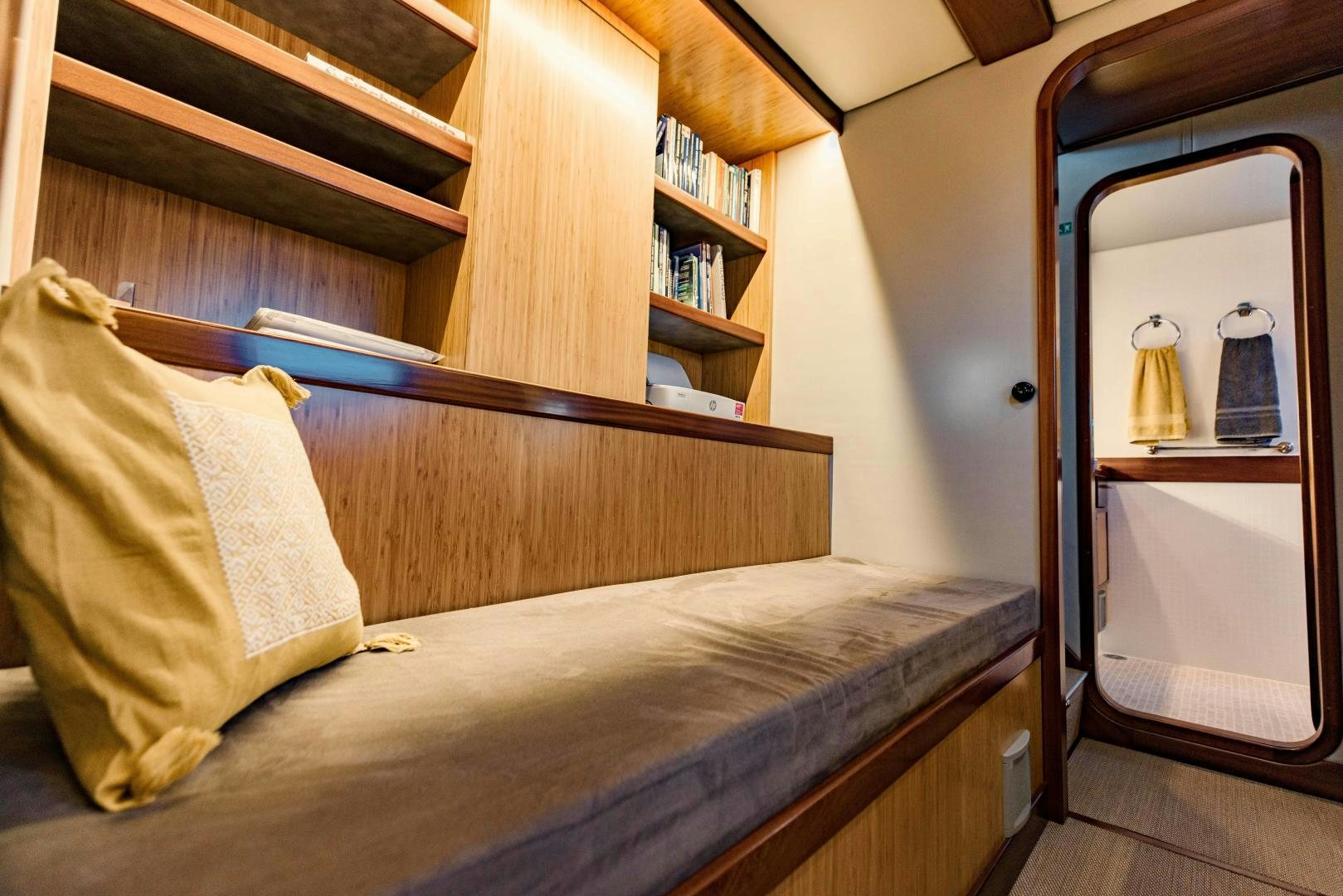 a bed with a mirror above it aboard IETA Yacht for Sale
