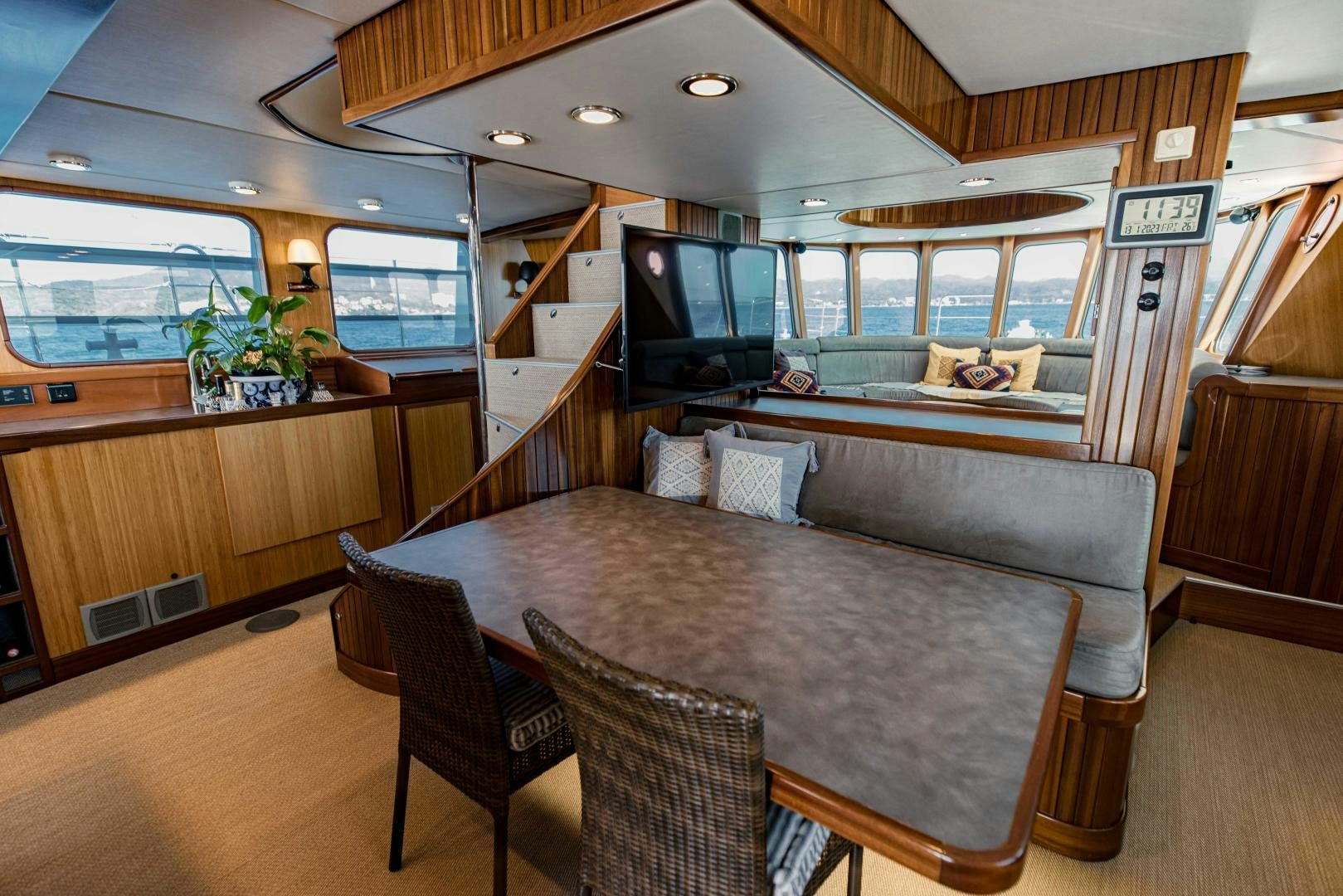 a large living room with a large table and chairs aboard IETA Yacht for Sale