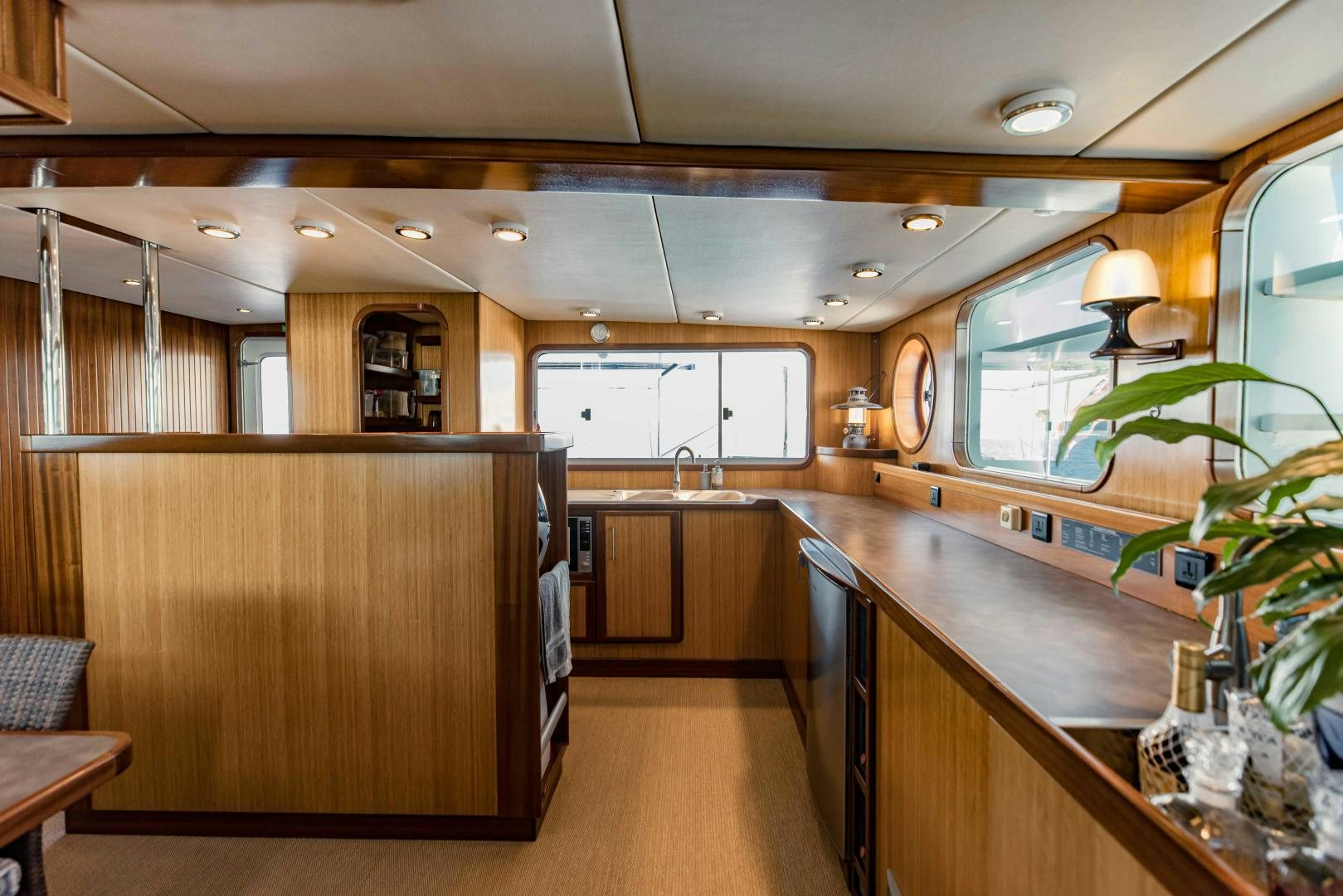 a kitchen with wooden cabinets aboard IETA Yacht for Sale