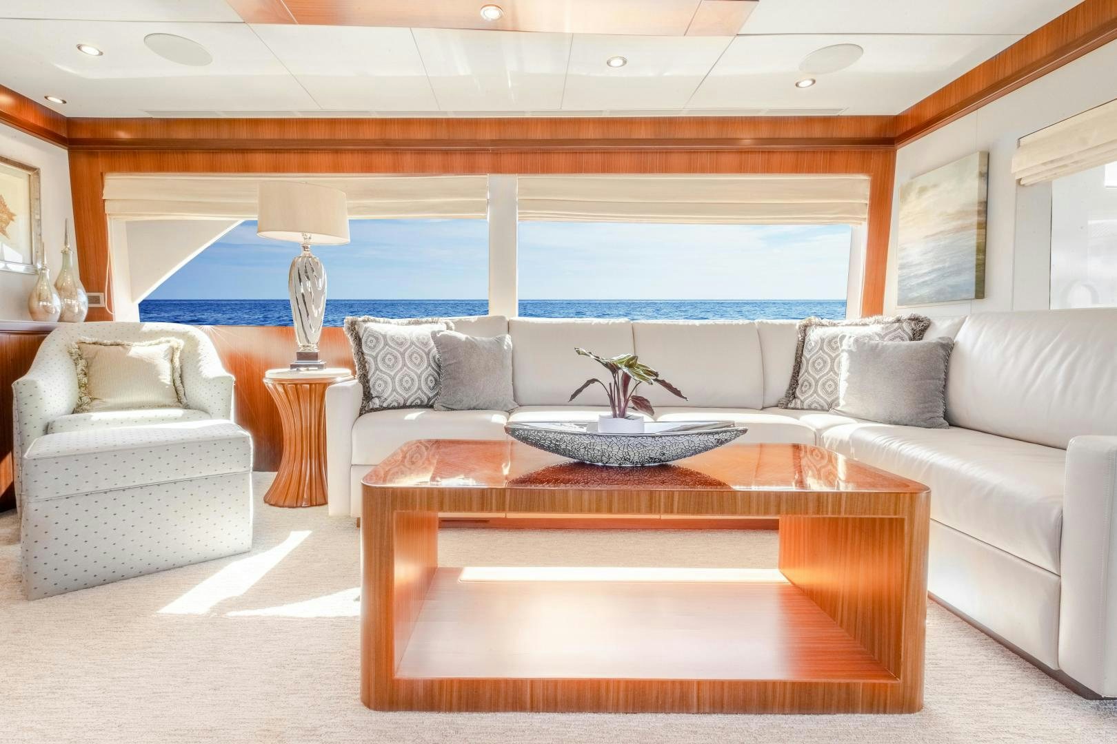 a living room with a large white sofa and a large coffee table aboard JOURNEY Yacht for Sale